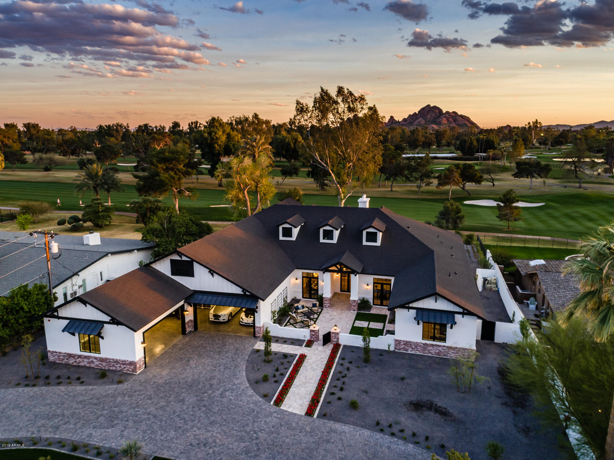 Seller is Motivated!  Bring an offer! Situated on the Prestigious Arizona Country Club in an incredibly quiet and serene location.  Golf course and Camelback mountain views create a private oasis right in the heart of Arcadia. This home features a split floor plan with 4 bed, 4 bath plus office and a theater/play room. An attached casita with separate courtyard entrance includes a full kitchen and additional suite with a 5th bed and full bath. Huge covered patios, a 5+ car garage with polished floors and built in steel cabinetry adds up to 9,300 SF under roof. Highlights include state of the art smart home technology, a 200 bottle glass wine enclosure,  Wolf / SubZero appliances, professional landscaping and interior design automated hidden TV's inside and out, expansive walk in pantry with an additional built-in fridge and freezer, and an outdoor kitchen with all the amenities. This home has the best of everything on a secluded private lot and is ready for it's new owners.