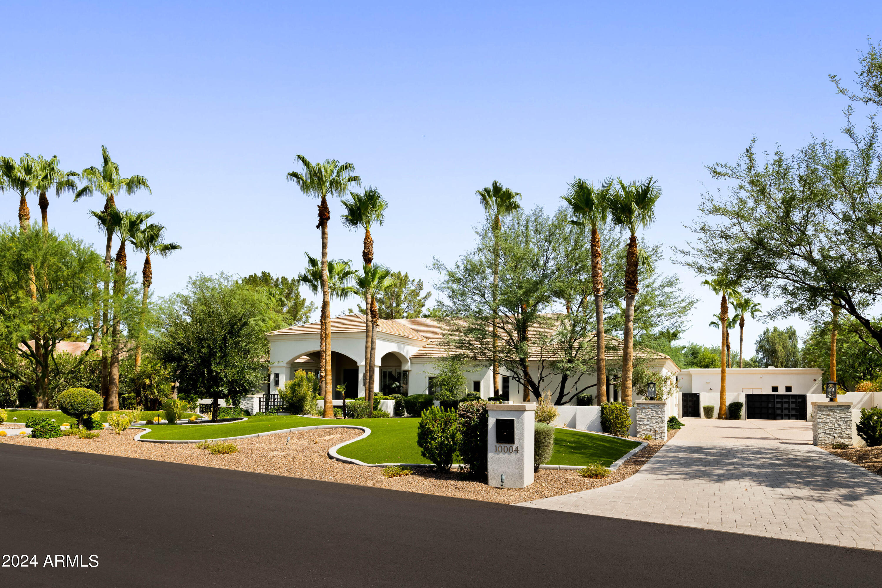 Located in the coveted enclave of Cactus Acres in North Scottsdale, this private estate offers a modern lifestyle of unparalleled comfort, privacy and convenience. Thoughtfully designed, this residence fosters both relaxation and pure fun. Whether a gathering or a quiet evening, multiple vignettes flow seamlessly from the living areas to the outdoor spaces. Complementing the main residence is a fully-equipped guest house, perfect for extended stays with family or friends. It mirrors the main home's style ensuring that your guests experience the same level of comfort you enjoy daily. The outdoor spaces resemble an intimate resort with a pool and spa, covered ramada, fire pit and built-in BBQ. This private sanctuary is moments away from award-winning shopping, dining and entertainment.