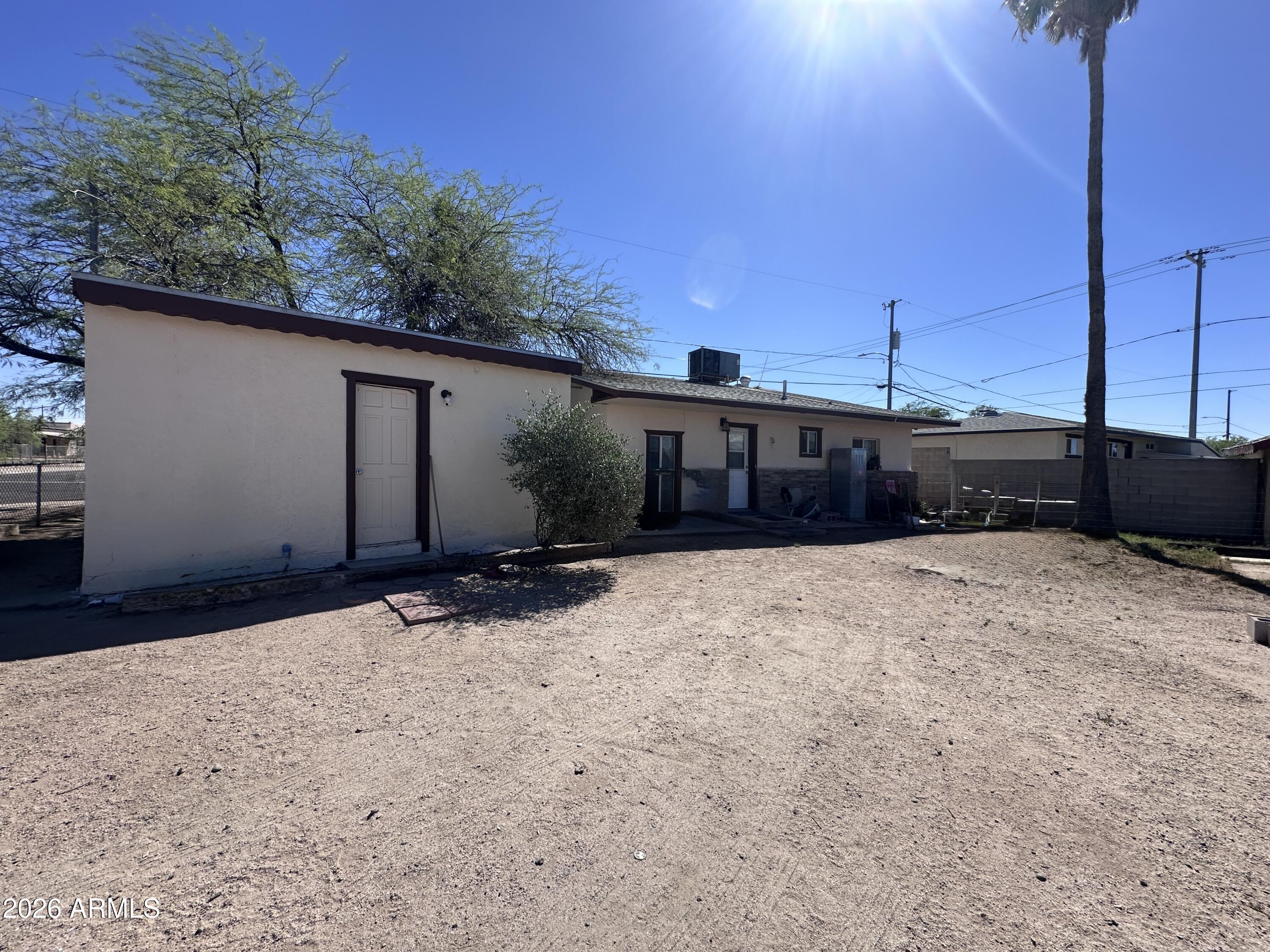 Own a property with two income opportunities for under $200K in Florence, Arizona. Main house plus detached casita. Ideal for long-term rental, traveling nurses, workforce housing, or house-hacking. Live in the main house and rent the casita to help pay your mortgage. Main house has 2 beds and 1 bath on a fully fenced corner lot with a detached casita/studio featuring its own kitchen with electric stove/range, mini fridge and bathroom. Great opportunity for rental income, guest quarters, or multigenerational living. Main home has eat in kitchen with gas stove/range and central HVAC (seller offering $10,000 credit towards a new HVAC system). Casita includes its own wall-unit cooling system. No HOA and conveniently located near Highways 79 and 287 for easy access and commuting.