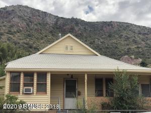 Great little home on corner lot just 7 steps from the street located in historic Old Bisbee. Perched up on the hill, this home on Quality Hill has beautiful panoramic views of Castle Rock and B Hill. Built in 1901 this 2bed/2bath home has large bay windows, plant shelves and skylights. Garage on separate tax parcel with electricity provides extra storage. Don't miss this great opportunity! Stop by and see it today!!