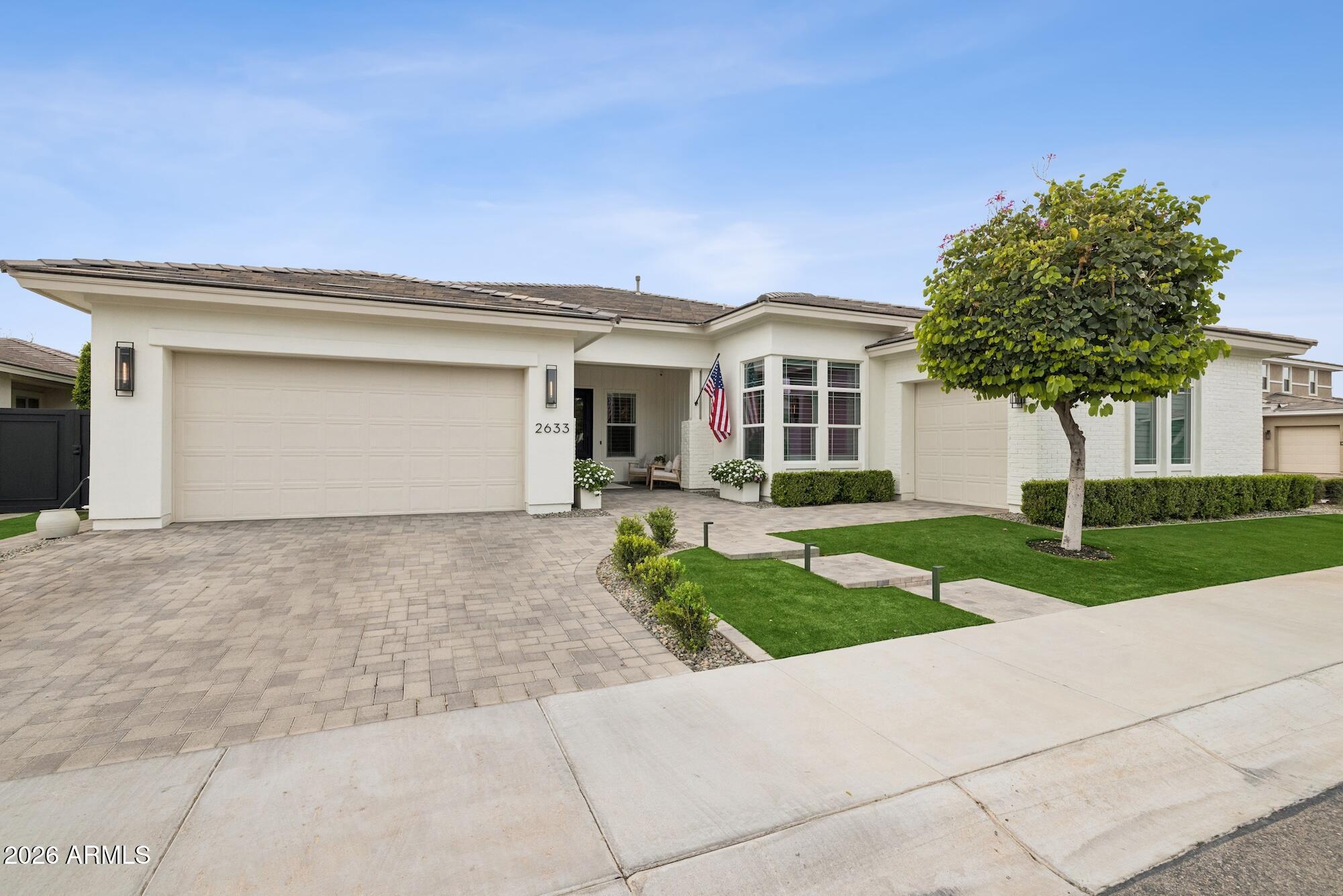 Designed with intention and built with exceptional attention to detail, this single-level residence is located within a private gated enclave and offers a refined blend of luxury, functionality, and timeless design. Spanning approximately 3,800 square feet with 4 bedrooms and 3.5 bathrooms, the home showcases custom craftsmanship and high-end finishes throughout, offering a level of detail and quality rarely found at this price point.

Wide-plank hardwood flooring, soaring ceilings, and abundant natural light set the tone from the moment you enter. The heart of the home is an expansive great room featuring custom built-ins, layered millwork, and a statement fireplace, creating a warm yet elevated space designed for both everyday living and entertaining. The chef's kitchen is equally impressive, complete with an oversized island, quartz countertops, custom cabinetry, designer lighting, and premium built-in appliances, blending functionality with elevated design. Seamless flow between the kitchen, dining, and living spaces enhances both daily living and entertaining.

The primary suite offers a private retreat with a spa-inspired bathroom and generous layout, while secondary bedrooms are thoughtfully positioned for comfort and privacy. Throughout the home, custom woodwork and architectural detailing add depth, character, and a level of finish more commonly found in higher price points.

Step outside to a resort-style backyard designed for year-round enjoyment. The pool features a Baja shelf, slide, and water features, complemented by a covered ramada with built-in BBQ, bar seating, and generous space to gather. Mature landscaping and privacy hedging create a serene, secluded setting.

Two air-conditioned garages finished with epoxy flooring and custom built-in cabinetry, offering elevated functionality and storage, ideal for car enthusiasts or those seeking additional flexible space. The freshly painted exterior, completed with premium Sherwin-Williams paint, enhances the home's crisp, refined curb appeal.

Located within a private gated community, this home offers a rare combination of thoughtful design, elevated finishes, and turnkey livability, delivering a level of quality and detail that is increasingly difficult to find.