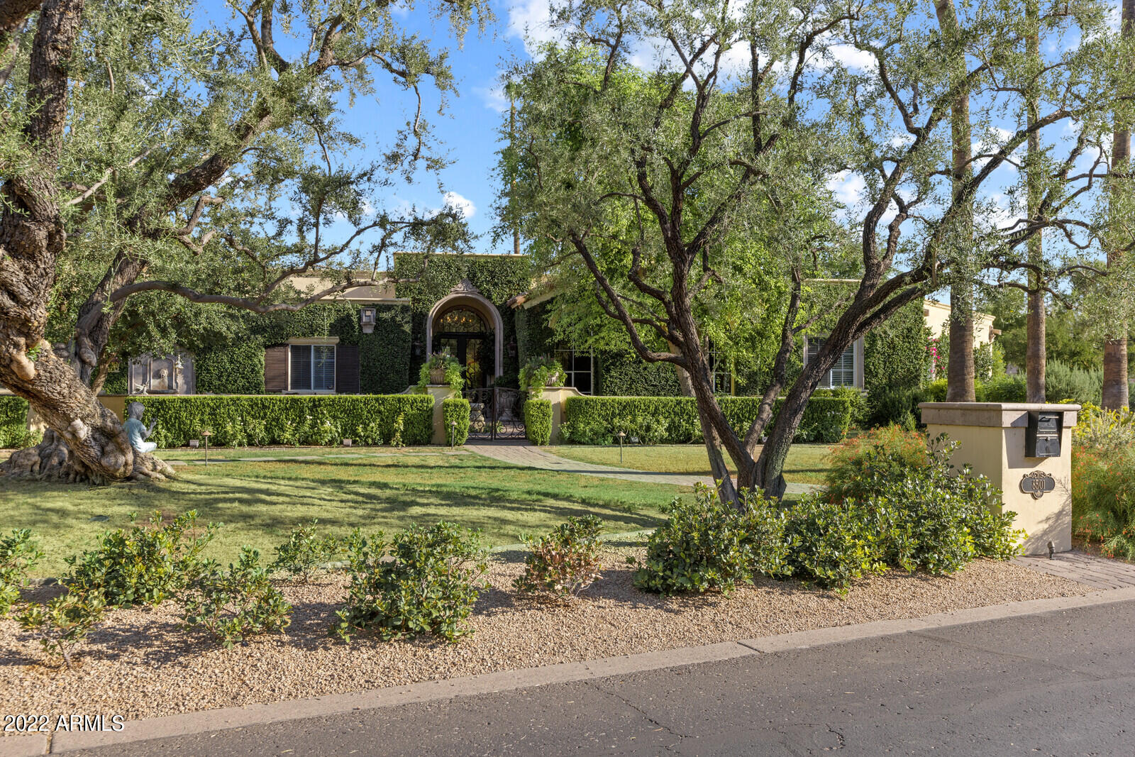 This elegant European-style estate, located in a highly desirable section of Paradise Valley, is beautiful at every turn. From the serene courtyard to the upscale interiors to the breathtaking backyard, every detail is intriguing. Situated on over an acre, the resort-like setting is spectacular with its lush grounds and luxurious patios. The sophisticated interiors include gorgeous windows and French doors throughout, beamed ceilings, hardwood floors and stone fireplaces. The well-appointed kitchen has custom cabinetry, marble countertops, double ovens, large island and connects with the spacious family room. The expansive owner's suite is gorgeous with large windows and doors that overlook the lovely backyard and a spa-worthy bathroom with sumptuous details that include two grand closets. The pool area is absolutely beautiful with its massive fountains and fireplace. This property is incredible and is even more impressive in person.