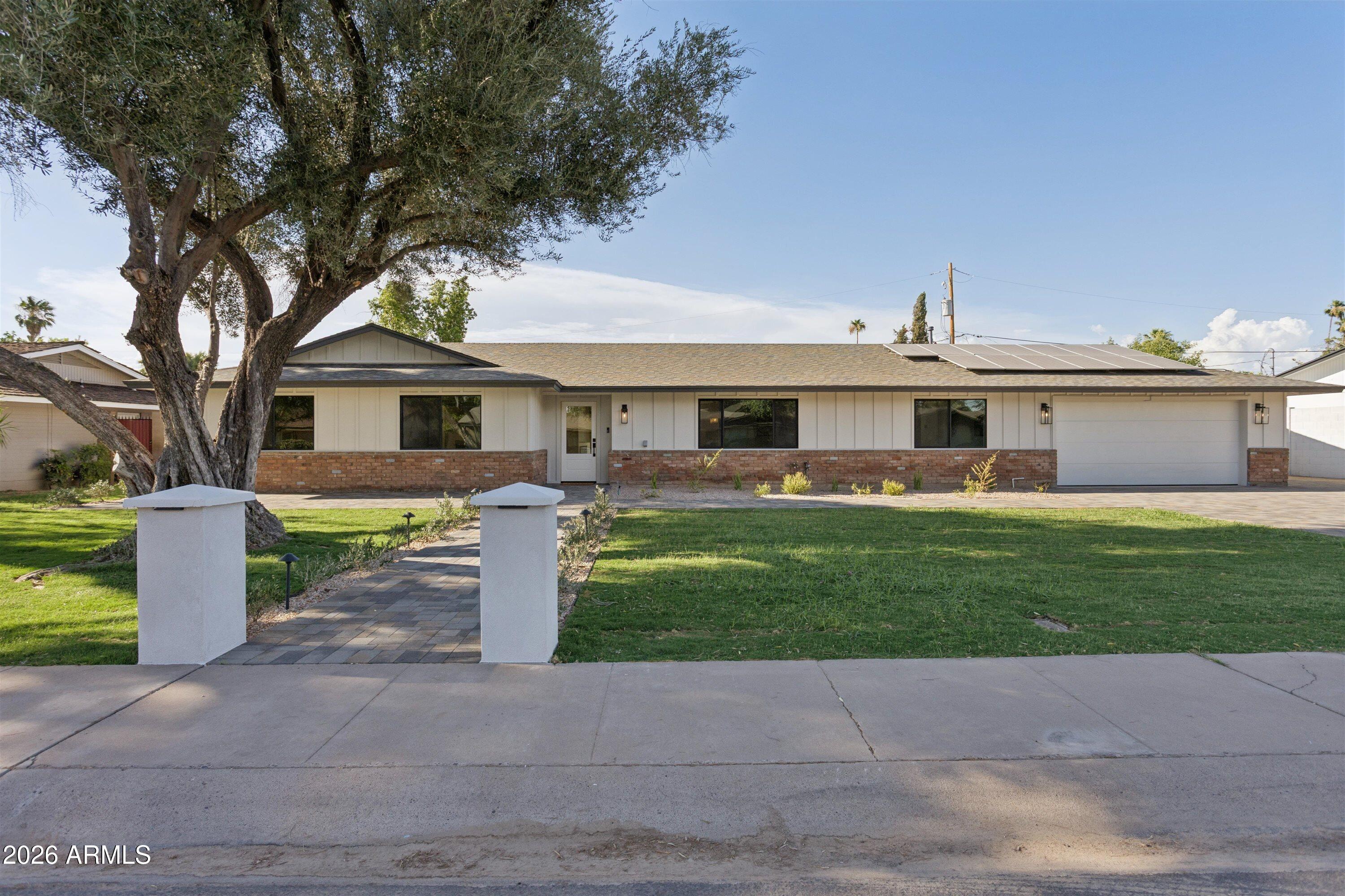 Nestled on a lovely cul-de-sac in the heart of North Central Phoenix, this quintessential ranch home seamlessly blends timeless charm with elevated modern design. Thoughtfully updated throughout, this 4 bedroom, 3 bathroom home showcases beautiful wide-plank oak flooring, designer-series cabinetry, and refined finishes that create a warm yet sophisticated aesthetic.

At the center of the home is a stunning chef's kitchen featuring striking Taj Mahal quartzite slabs, custom cabinetry, and GE Cafe series appliances including a 48' range--perfect for both everyday living and effortless entertaining.

The primary retreat offers a luxurious spa-like bathroom complete with dual his-and-hers vanities and thoughtfully curated finishes. Step outside to a true resort-style backyard designed for year-round Arizona living. Enjoy a sparkling pool surrounded by over 1,200 square feet of travertine patios, extensive mature landscaping with an automatic watering system, and a beautifully appointed ramada featuring a tongue-and-groove ceiling and built-in barbecue--creating the ultimate setting for entertaining family and friends.

Ideally located with easy access to the Murphy Bridle Path, Uptown Phoenix's acclaimed restaurants, and beloved local favorites, this exceptional North Central property offers the perfect blend of lifestyle, luxury, location, and the peace of mind that comes with new plumbing, electrical, and roof!