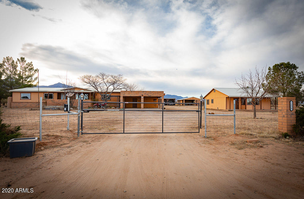 Enjoy stunning desert sunsets and mountain views from this 3 br 2 ba home on 4 fully fenced acres in a great Hereford location. The 1 br 1 ba guest house is the ideal Mother-in-Law quarters or private space for other visitors. Enclosed barn with loafing shed is perfect for horses. Attached 2 car carport includes large built-on workshop. The detached 3 space carport in the back is great for extra parking for vehicles or lawn equipment. Full RV hookup.