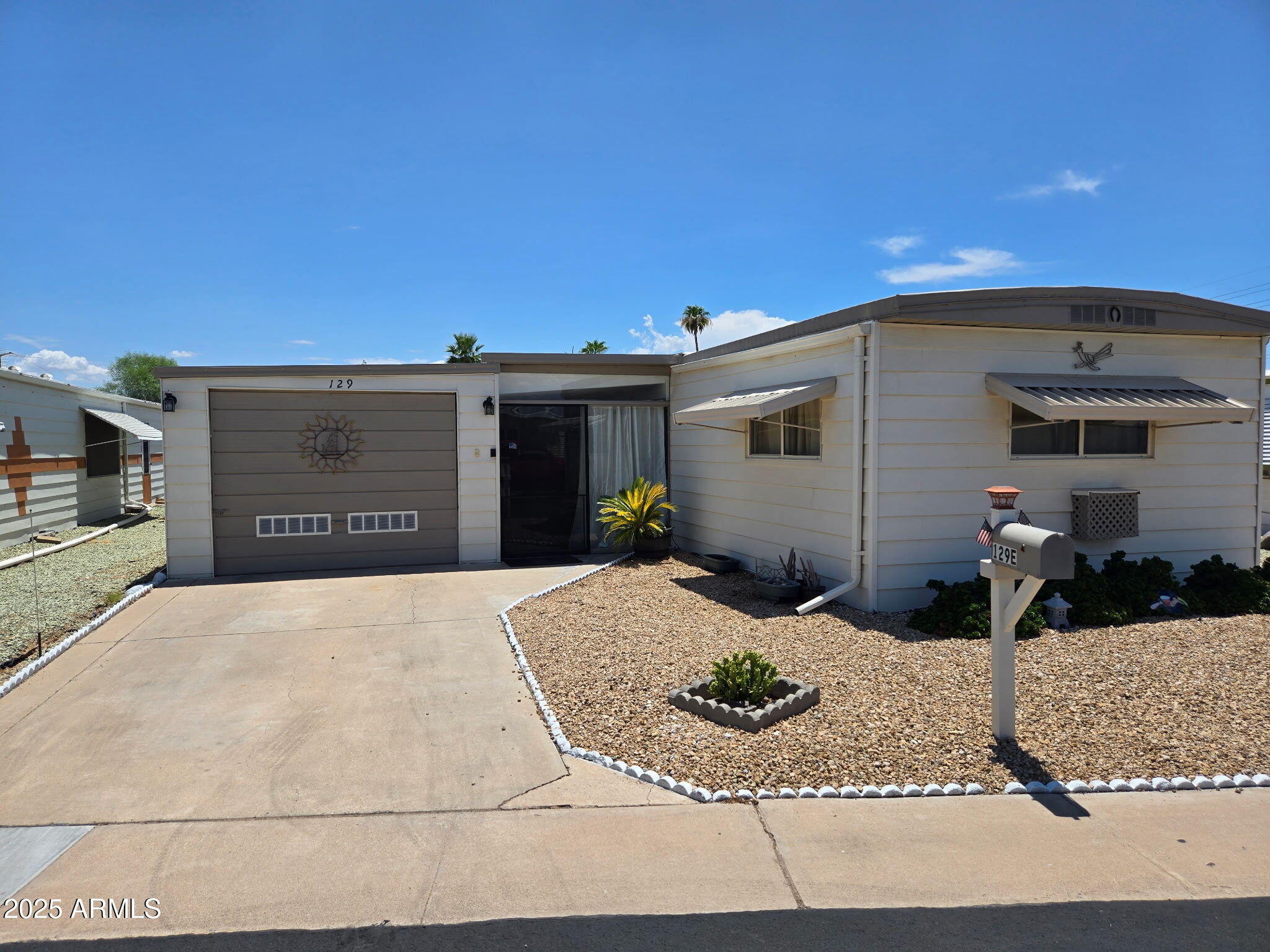 Complete remodel 3 years ago! Priced for a quick Sale! Located in a remodeled 55+ community, this home features a bright and uplifting interior with a modern flair. The added Garage and huge enclosed AZ room are a rare find in Mobile Home communities.  The home is ground set with just a slight step up for easy access. This home has more outstanding features than space allows to describe! Come and see this home before it is too late.