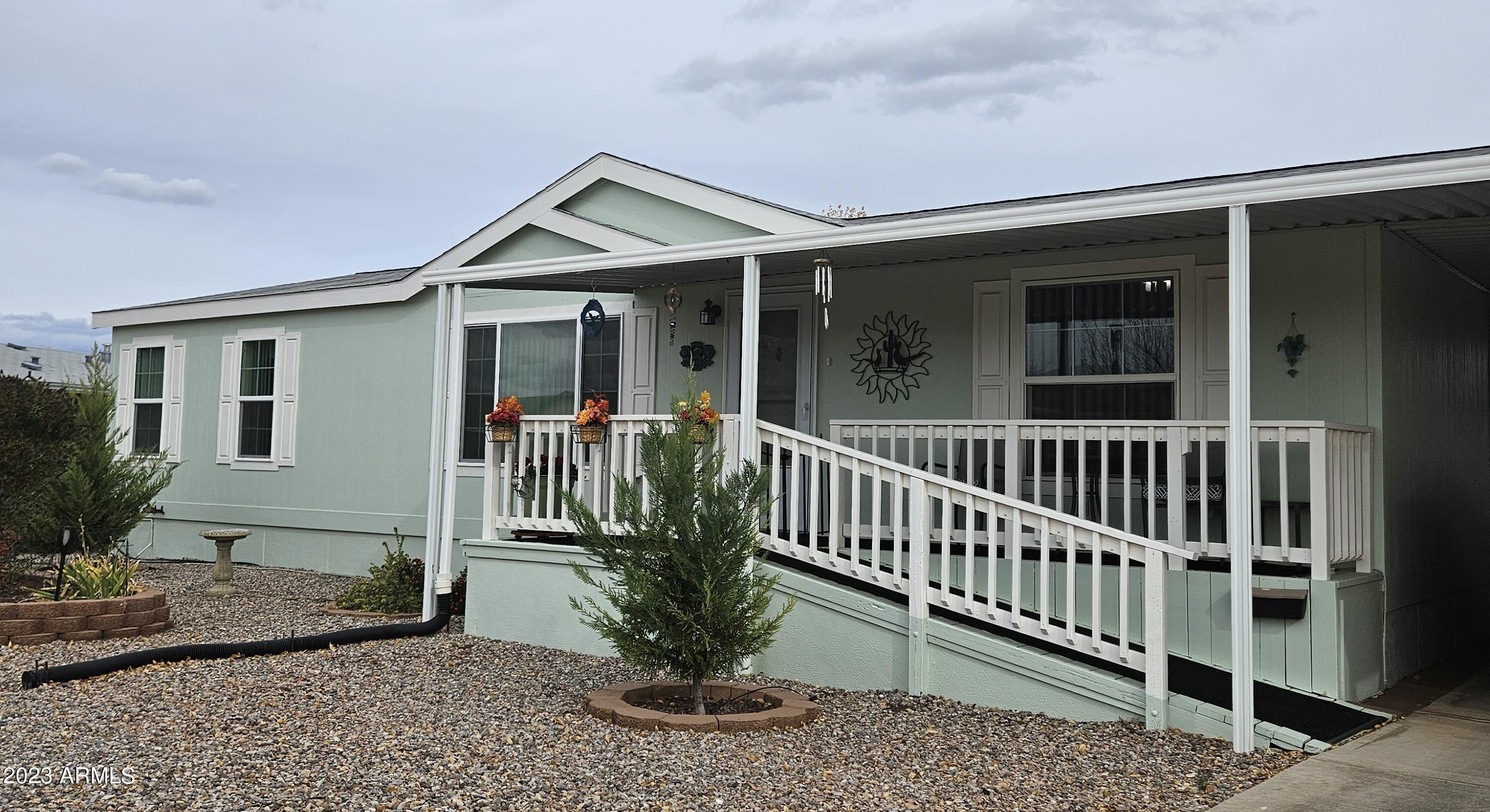 This lovely home offers that peaceful, easy feeling that we are all looking for!!! Very clean and well maintained. 3 bedroom, 2 bath. Large, comfortable rooms in this 1,512 square foot split floor plan home. Walk in pantry, utility room with additional space for a freezer or even more storage. Front (with Ramp) and rear covered decks. Premium, spacious lot with small area of chain link in back yard. Pum Crete ( formed concrete) type skirting. Large shed with three nicely done additions. Easy care landscape using primarily the Xeroscape style. This really is a nice one! The park is gated and offers two club houses. Outdoor pool, indoor pool and spa. Welcome home!