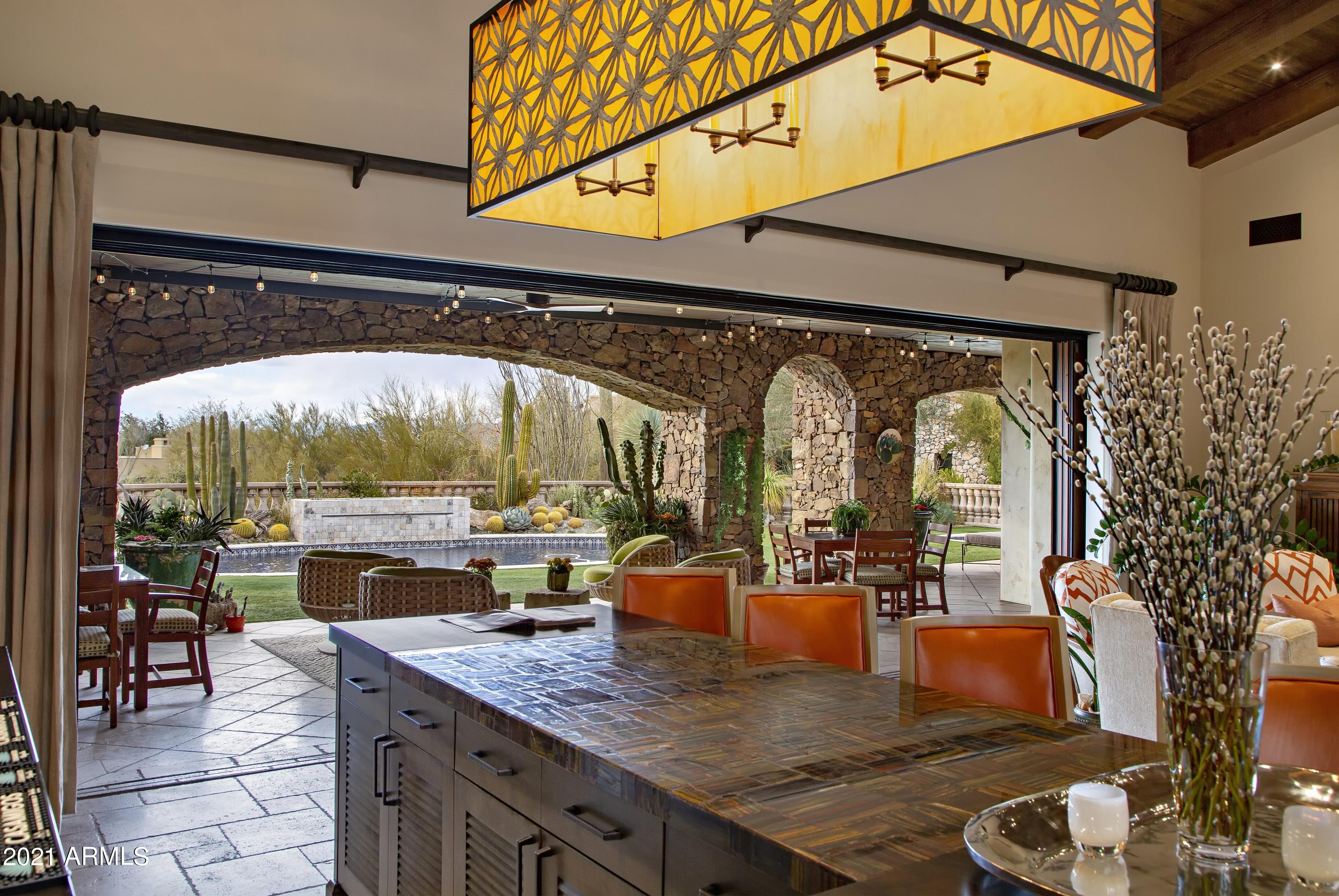 Authentic Santa Barbara-style on an elevated view lot in Estancia * Recently remodeled to create a timeless, warm feel with spaces reminiscent of a luxury Montecito inn * Perfect floor plan with the master bedroom, all living areas and guest bedrooms on one level and a Junior master as the only upstairs retreat  * Amenities include a dedicated office, large theater room, massive great room with wet bar and motorized pocket door to the outdoor living room, 1000+ bottle wine cellar, detached guest house with kitchenette and a 4-car garage * Interior details include stone and wood plank flooring, carved cantera fireplace surrounds, wood beamed ceilings and custom lighting fixtures * Resort-style outdoor living with heated pool/spa, fireplace and fire pit, built-in BBQ station, in ground