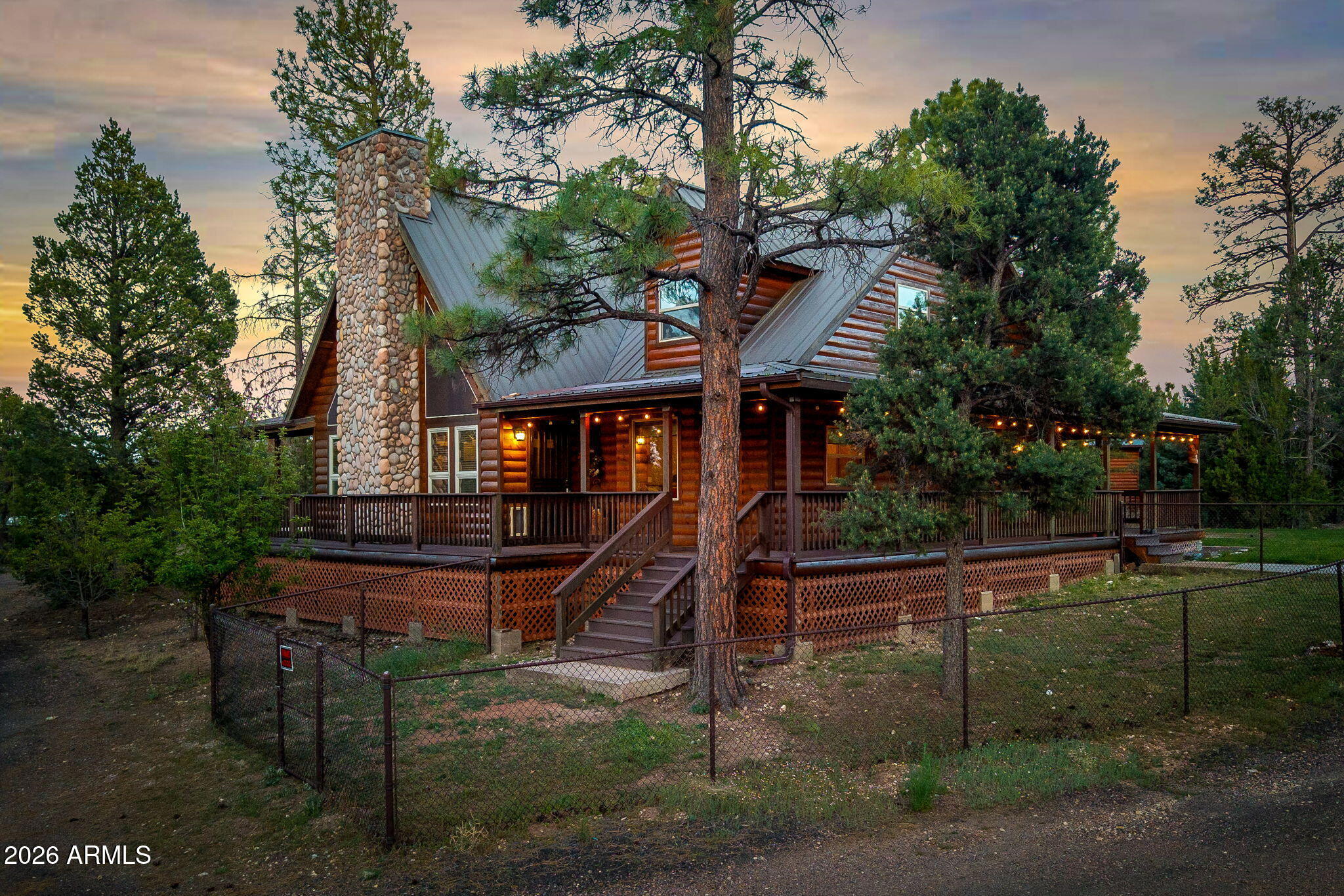 Escape to your own private mountain sanctuary on 2.61 acres surrounded by towering pines in the heart of the White Mountains. This exceptional chalet-style retreat combines timeless rustic charm with upscale mountain luxury, offering 3,000 sq ft, 4 bd/3 ba designed for both relaxation and entertaining. From the moment you step inside, you're greeted by soaring ceilings, expansive windows, and rich wood finishes that flood the home with natural light while showcasing the warmth and character of true mountain living. The spacious gourmet kitchen is thoughtfully designed with abundant cabinetry, extensive counter space, and generous storage, seamlessly opening to the dining area and inviting great room which creates the perfect gathering space for family and friends At the center of the home, a stunning floor-to-ceiling stone fireplace with pellet stove insert sets the stage for cozy winter evenings. Upstairs, you'll find additional bedrooms and a spacious loft overlooking the great room below, ideal for a second living area, game room, office, or reading retreat. Ample storage throughout adds convenience and functionality for full-time living or the perfect vacation getaway. Step outside to enjoy the expansive Trex wrap-around deck where you can relax, entertain, and take in the peaceful forest setting and cool mountain air. The property also features a durable metal roof, sprinkler system, and plenty of open space to enjoy the beauty and privacy of the outdoors. Adding even more value and versatility is the impressive detached 3-car garage with a massive 1,200 sq ft loft above, complete with its own full bathroom along with heating and cooling. Whether used as guest quarters, a game room, studio, home office, or additional living space, the possibilities are endless. Bring all your toys, ATVs, trailers, and outdoor gear there is for it all! Located just a few homes away from National Forest access, adventure awaits with endless riding, hiking, and exploring right at your doorstep. This rare White Mountains property offers the perfect blend of privacy, luxury, and year-round recreation which makes for a true mountain escape you'll never want to leave. Come take a look today!