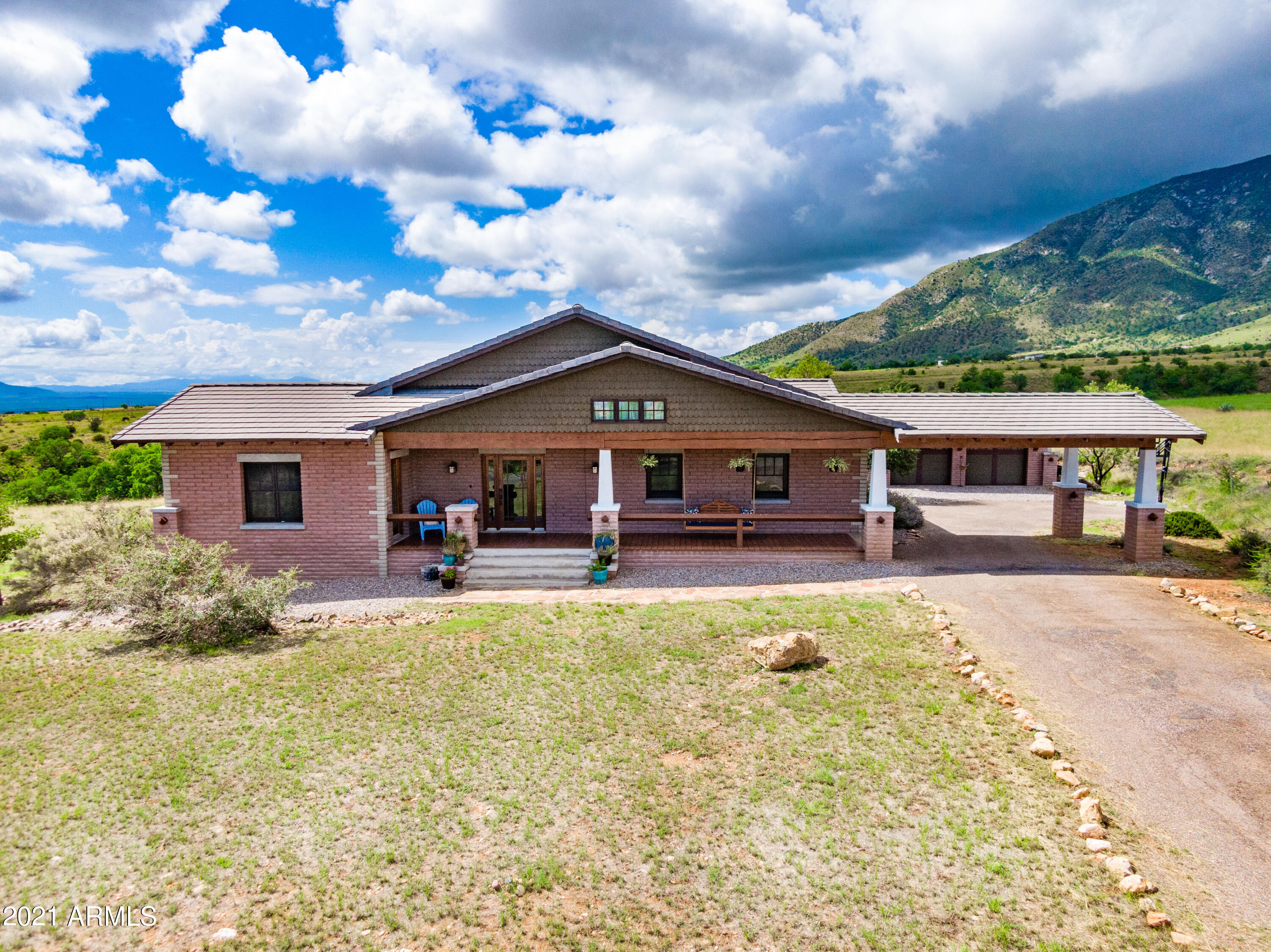 Unique opportunity to own an impressive Craftsman Style home on nearly 4 acres.  This stunning home is spacious, warm, filled with intricate details and views that will amaze you!!!  You'll be able to easily view the Huachuca & Mule Mountain ranges.  4 bedrooms, 3 bathrooms, large bonus room and so much more. Brand new washer & dryer convey with the sale. Come take a seat on the fantastic, custom porch swing and take in the striking views!!!