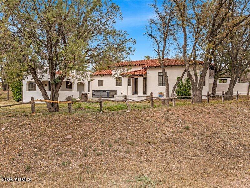 Historic Southern Arizona Ranch. Discover a sanctuary in the Oak Forest where the raw power of nature meets human history. This historic ranch isn't just a property; it's a vortex of beauty that demands to be experienced. The estate boasts seven updated units, anchored by a stunning 2,600 sq. ft. adobe manor. From the site-sourced oak vigas to the original hand-hewn hardware and hardwood finishes, every inch feels like an authentic time capsule. This home is a labyrinth of cozy fireplaces and enchanting crannies that evoke a vibe long forgotten. Outside, 80 acres of pristine land are bordered on two sides by State Land, creating an infinite backyard accessible through your own private gates. The property is fully equipped for world-class equestrian use with a new tack room & stallion arena