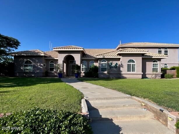 This amazing WELL MAINTAINED home HAS IT ALL! Enjoy the stunning mountain views while basking in the Arizona sunshine and soaking in the pool or spa. This PRISTINE home includes a central vacuum system, 2 gas fireplaces, laundry room w/sink & ceiling fans throughout. Above the garage is a HUGE GREAT ROOM with a wall-to-wall built-in bookcase, gas fireplace, office area & storage. The Master Suite boasts His n' Her walk-in closets & sinks, a private toilet room, garden jet tub & separate shower with 2 heads. The kitchen is a ''Chef's Delight'' with LOTS of cabinet & counter space, breakfast bar, walk-in pantry & all you need to whip up a delicious meal! The beautifully landscaped exterior includes RV hook-ups, 2 sheds & 5 fruit trees! Check out the  ALL-house generator & HUGE workshop!