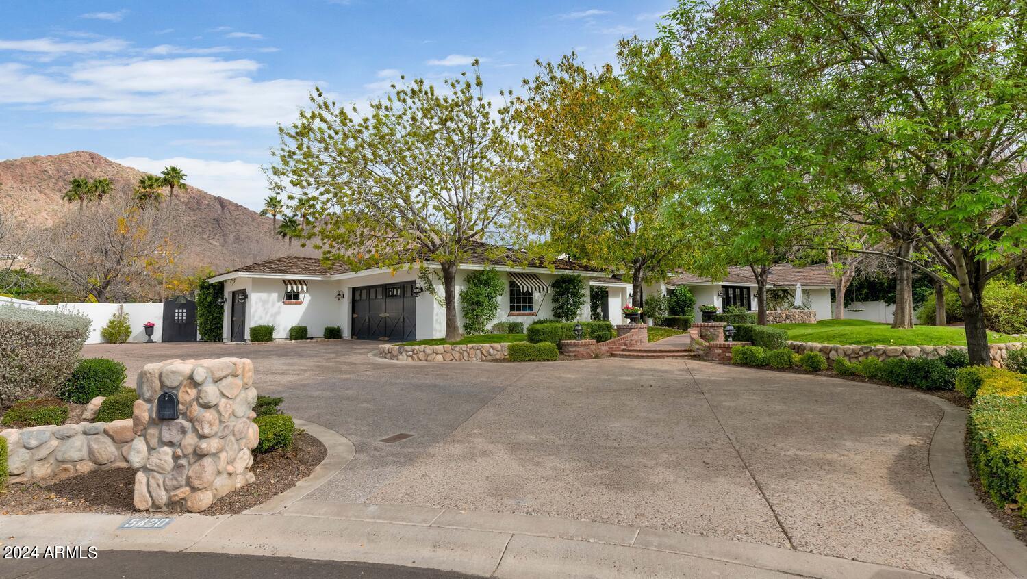 This is the quintessential Arcadia home that every family dreams of owning. The sprawling ranch is loaded with character
and perfectly combines elegance and livability. The beautiful island kitchen has gorgeous custom cabinetry, great spaces to prep and serve and an adjacent sun-soaked breakfast room.  The great room makes a bold statement, the den is a dream space for kids and adults alike, the formal dining room has a temperature-controlled wine room, and all of the bedrooms and custom baths are outstanding, including an exquisite
primary suite with its own office/exercise room and sitting area with a great looking exposed brick fireplace.  French doors
surround the home and each open to another lovely covered or uncovered patio, and the grounds are absolutely magnificent with a phenomenal walk-up bar, firepit with room for 10, an
additional fireplace, sport court, bocce ball, fabulous pool and
spa, and absolutely breathtaking mountain views. This is a
dream home that calls for birthday parties, cocktail parties,
weddings, and all sorts of outdoor soirees, and it sits in the
back of a quiet cul-de-sac on a stunning lot. It's as warm as it is
sophisticated and as charming as it is grand, and it's a place
where every child would love to grow up and generations of
adults would love to enjoy!