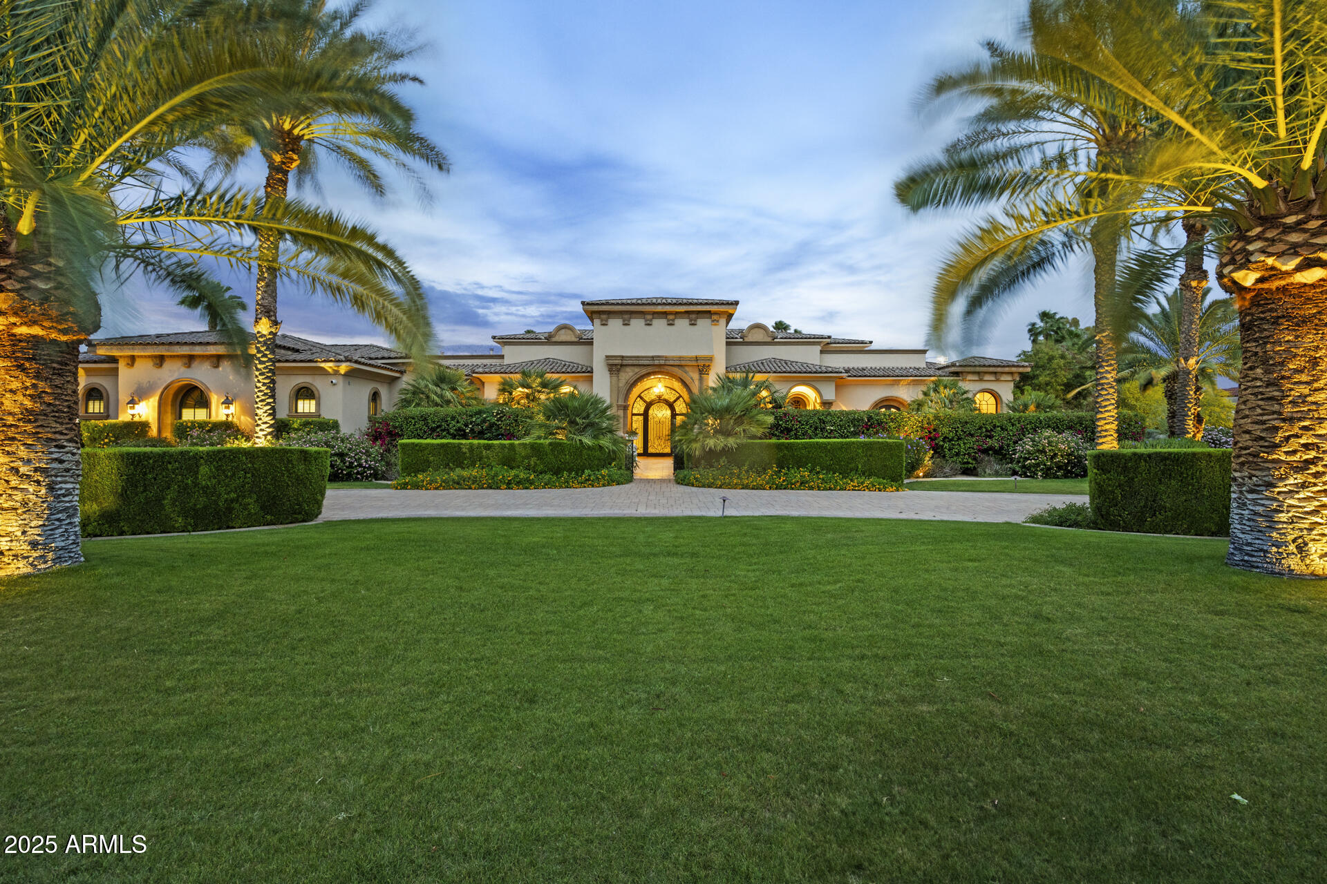 Paradise Valley living is a unique experience in the Valley of the Sun because of the distinctive style of estates that are exclusively designed for the homeowners. This beautiful 9,900+ Sq. Ft. home presents 7,200 Sq, Ft. of living space on the main level, including the primary ensuite which includes a massage room and sauna. Featuring spectacular architectural design details that seamlessly blend Old World Mediterranean elegance and charm with contemporary amenities, this home is warm and welcoming. Your family and friends will join you for the ultimate experience in at-home entertaining with the movie theatre, outdoor living space, resort style pool, game room, sauna, spa and gym. The lush estate grounds provide a serene atmosphere to enjoy with those you love, and the home itself is reminiscent of a time when grand estate homes were gorgeous retreats from the hustle and bustle of everyday life. Highlights include, but are not exclusive to European White Oak hardwood floors, soaring ceilings, coffered ceilings, elegent fixtures, honed granite fireplace in family room, floor to ceiling limestone fireplace in living room, control 4 system, architectural details, Chef's kitchen with two islands, porcelain countertops, walnut cabinets, Wolf and SubZero appliances, plus a full wet bar. The main level primary suite features a private sitting room, gym/massage room, two generously sized walk-in closets, stackable washer/dryer closet and sauna that opens to the courtyard, a junior guest suite complete with a kitchenette and stunning French Doors that open to the front courtyard, a basement with a game room, movie theatre and temperature controlled wine room. And that's just the beginning of what is inside! Your outdoor living area features an over-sized covered patio with cooking center and endless views of the grand hotel influenced pool, fountain and the mature lush landscaping. Even the 4-car garages are updated with an epoxy floor and wiring for a car lift and two 220V 60 amp car charging stations. Your new estate residence is close to the heartbeat of Scottsdale, Scottsdale Rd & Shea Blvd, so you will be minutes from golf courses, spring training, parks, shopping, dining. entertainment, schools, West World, Odysea, Talking Stick resort and Old Town Scottsdale. Welcome home!