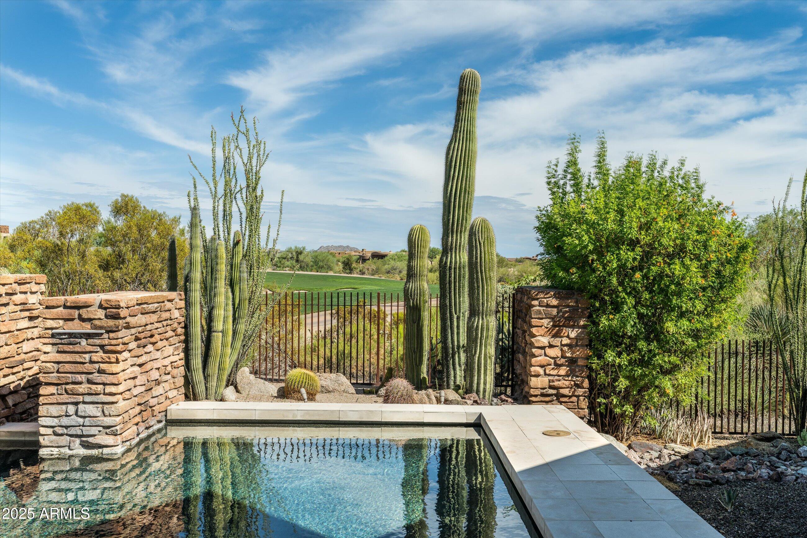 GOLF MEMBERSHIP AVAILABLE - 
This classic desert contemporary is a light-filled open-concept floor plan where soaring ceilings, warm natural textures, and walls of glass invite the outdoors in. Designed for both grand entertaining and intimate living, the home features a dramatic great room with telescoping glass doors that extend the living space  seamlessly connecting the interior with the breathtaking desert landscape beyond.
At the heart of the home is a chef's kitchen appointed with premium appliances, granite countertops, butlers pantry,  a wet bar w/wine room, and an adjoining both formal dining and casual dining areas, perfect for hosting gatherings both intimate or grand.
The luxurious primary suite offers a tranquil escape, complete with fireplace, sitting area,  spa-like bath, generous walk-in closets, and direct access to your private patio and the pool terrace. Three additional ensuite bedrooms, including a private guest casita, provide comfort and privacy for family or visitors, while the dedicated office and theater room ensure flexibility for modern living.
Outside, enjoy true resort-style living with a sparkling heated pool, elevated spa, built-in barbecue, and fireplacesall overlooking sweeping Renegade golf course views framed by the rugged beauty of the Sonoran Desert and mountains. 
Outdoor private paradise features multiple patio dining and lounging areas, pool, elevated spa, built-in barbecue, fireplace, mountain views and lush desert landscaping all overlooking Renegade's 2nd perfect for alfresco living year-round.........it's a lifestyle. From its architectural finesse to its resort style amenities, it appeals to those who seek privacy without compromise, luxury without ostentation, and community without crowds. Whether as a family haven, a full-time residence, or a refined retreat, this residence in Desert Mountain delivers on every front.