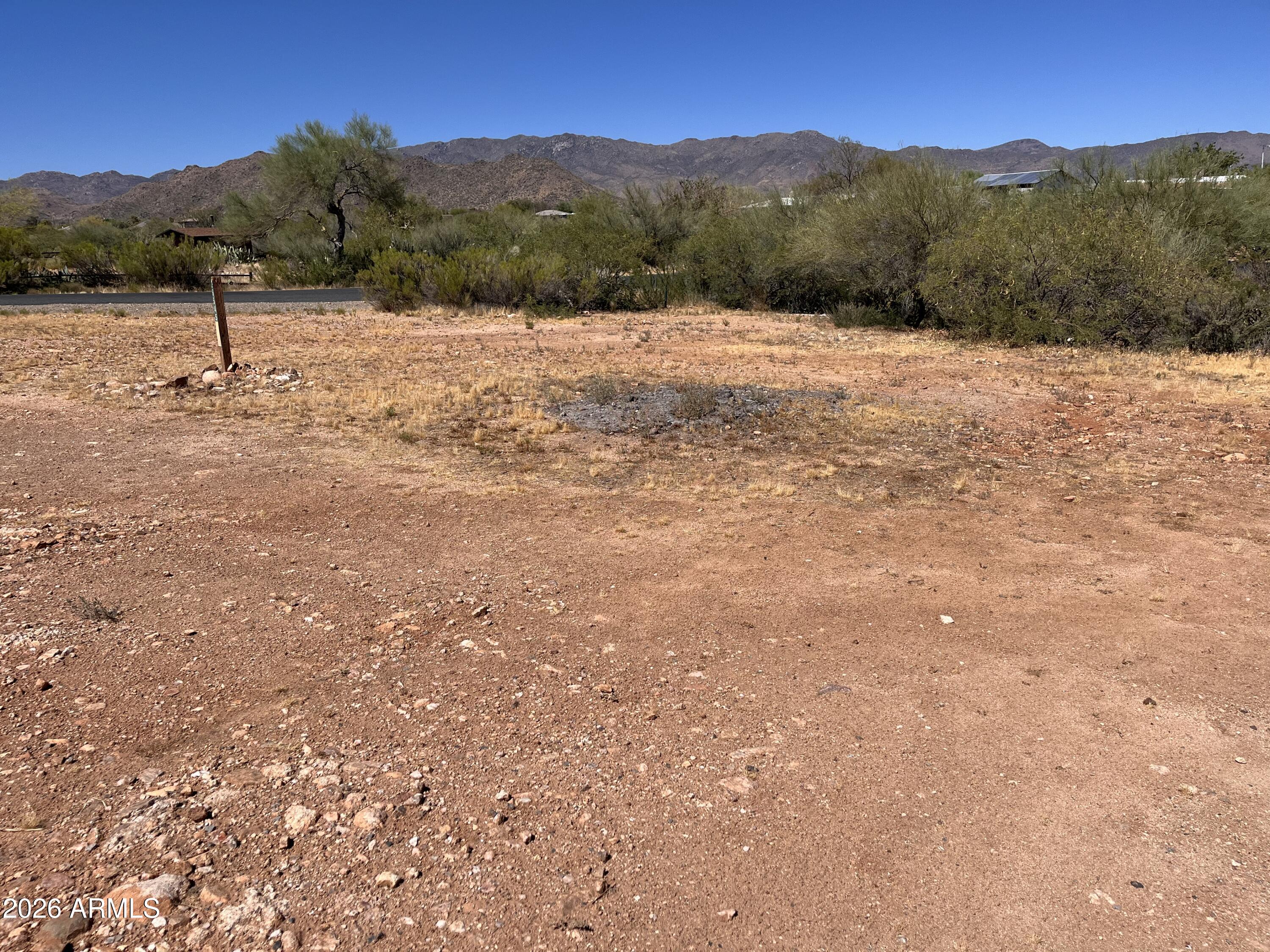 Where high desert meets open sky, opportunity takes root. This 0.36-acre corner lot in Congress, AZ invites you to build the life you've pictured--custom or manufactured home, no HOA. Framed by mountain views and natural desert vegetation, the gently sloping parcel offers street access on three sides via county-maintained asphalt roads. The groundwork is done: site survey and percolation test completed and recorded with Yavapai County, with utilities at or near the property line. Zoned R1-10 in unincorporated Yavapai County--raw land ready for your vision. A portion lies within a designated flood plain; buyer to verify all utilities, zoning, and building requirements with the county.