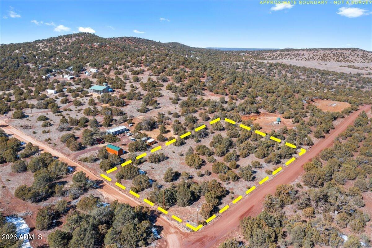 This elevated vacant parcel offers a peaceful setting in Arizona's high-desert juniper country, with wide open skies and dark, star-filled nights. Located on a county-maintained road, the property provides easy access while still delivering privacy and quiet. The lot features a gently elevated landscape with excellent potential for either a site-built home or a mobile home installation. Power is available at the lot line. Come check it out!
