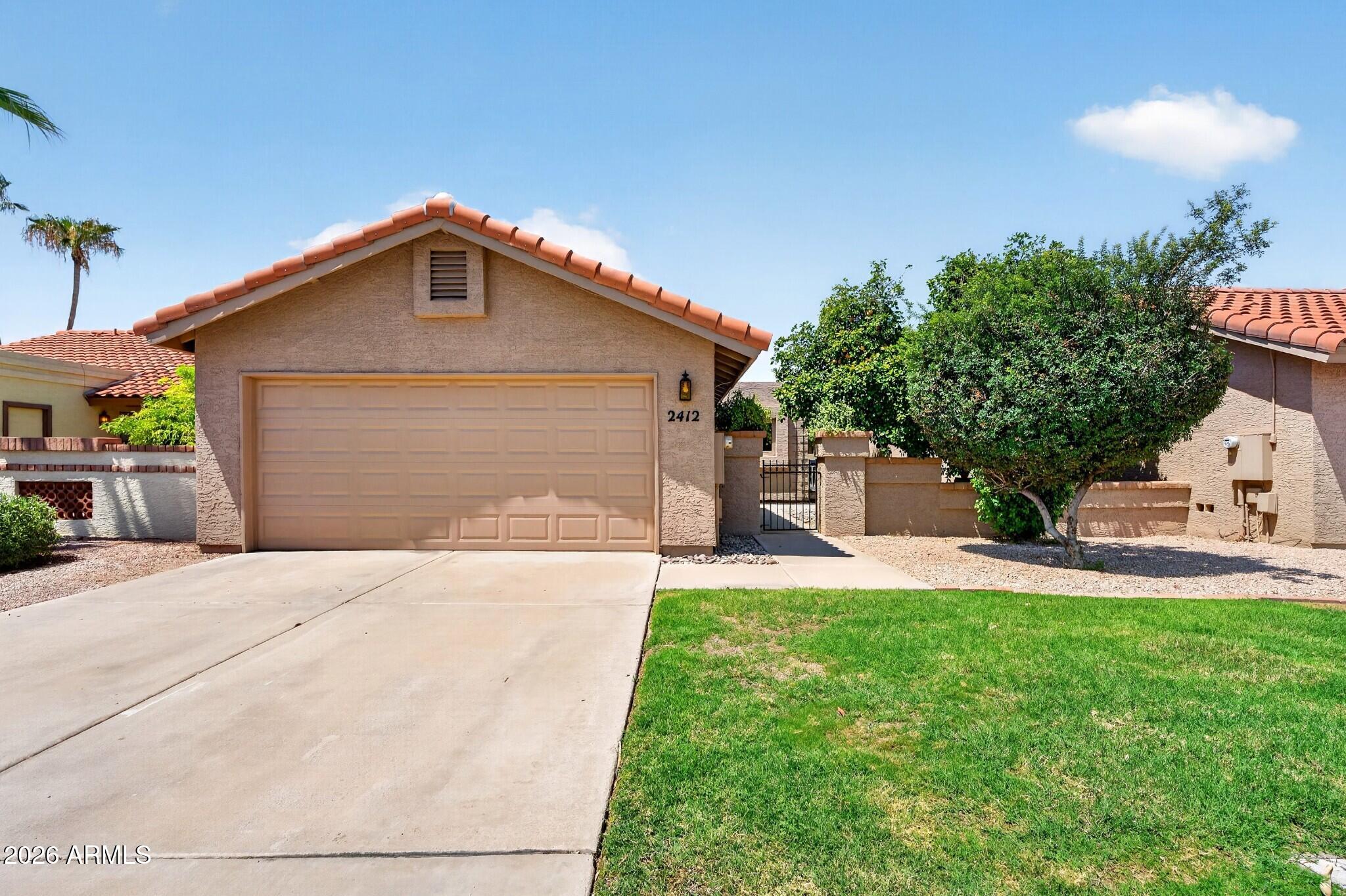 Welcome to this inviting home in a desirable Chandler location! New roof (2026) and new AC (2025). The bright, open interior features soaring ceilings, warm neutral tones, and a spacious living room with a cozy fireplace. The eat-in kitchen offers abundant cabinetry and generous counter space. This unique floor plan includes two spacious primary suites. One features a large walk-in closet, while the other offers dual closets and private access to the backyard. Tile flooring runs throughout the home, no carpet. Step outside to a covered patio, low-maintenance landscaping with artificial turf, and plenty of space for relaxing or entertaining. Residents can also enjoy the community pool, perfect for cooling off during Arizona's warmer months. Conveniently located near the Loop 101 and walking distance to the elementary and Jr. high school. This Chandler home is ready for its next lucky owner!