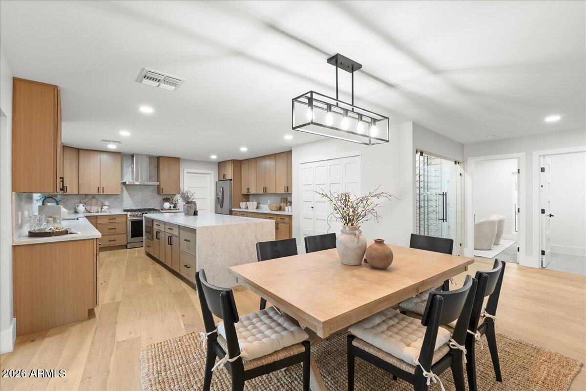 ''Priced below appraisal value.'' Step into refined luxury living in this fully remodeled ranch-style estate, perfectly positioned in the highly sought-after Old Litchfield Park community on the 14th hole of the Wigwam Gold Golf Course. This home blends timeless elegance with modern design, offering breathtaking golf course and sunset views that elevate everyday living.
Spanning approximately 2,900 square feet, this exceptional residence features 4 spacious bedrooms and 3.5 beautifully appointed baths. The expansive great room flows seamlessly into a show-stopping open kitchen, designed for both entertaining and everyday comfort. Highlights include a massive waterfall-edge island, striking stone countertops and full backsplash, gas range, and a dramatic stone gas fireplace anchoring the space. A designer wine room with custom tile adds a sophisticated touch, perfect for hosting and showcasing your collection. Retreat to the luxurious primary suite, where spa-inspired finishes await an oversized soaker tub, an elegant tiled shower with dual rain shower heads, a private water closet, and a custom designer closet that completes the experience.
Throughout the home, white oak wood flooring and thin-shaker oak cabinetry deliver warmth and understated luxury. Outside, enjoy Arizona living at its finest with a large covered patio, resort-style pool, and unobstructed golf course views ideal for relaxing evenings and unforgettable sunsets.
Set on an impressive almost half-acre lot, the property also features a grand half-circle driveway and a porte-cochère entry, adding both curb appeal and convenience.
This is a rare opportunity to own a luxury golf course home in one of the West Valley's most iconic neighborhoods where elegance, comfort, and lifestyle come together seamlessly.
