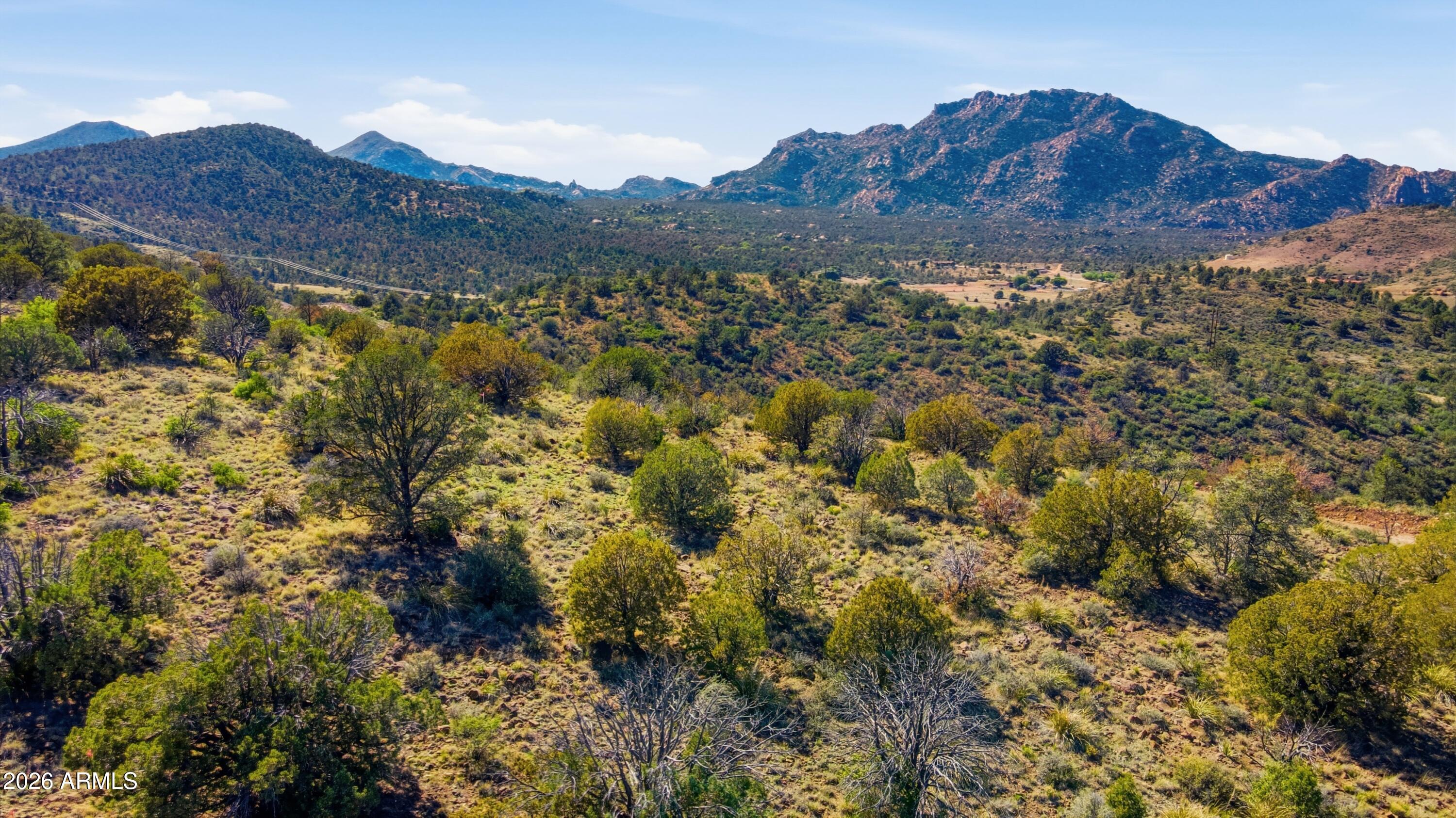 Welcome to Prescott's latest custom home development with a lot/home package offered by award winning Crystal Creek Builders.  The home design is at the buyer's degression, which may include a picture frame window of San Fransico Peaks!  The elevated gently sloping building site offers exceptional panoramic mountain views from the east to west including Granite Mountain & San Fransico Peaks. Located in master-planned gated development of Stringfield at Granite Mountain, which offers 700 acres of premium view one to three acre homesites, lots of open space, and borders Prescott National Forest .  The feeling of Prescott mountain country living with the conveniences of city water/sewer, & natural gas.