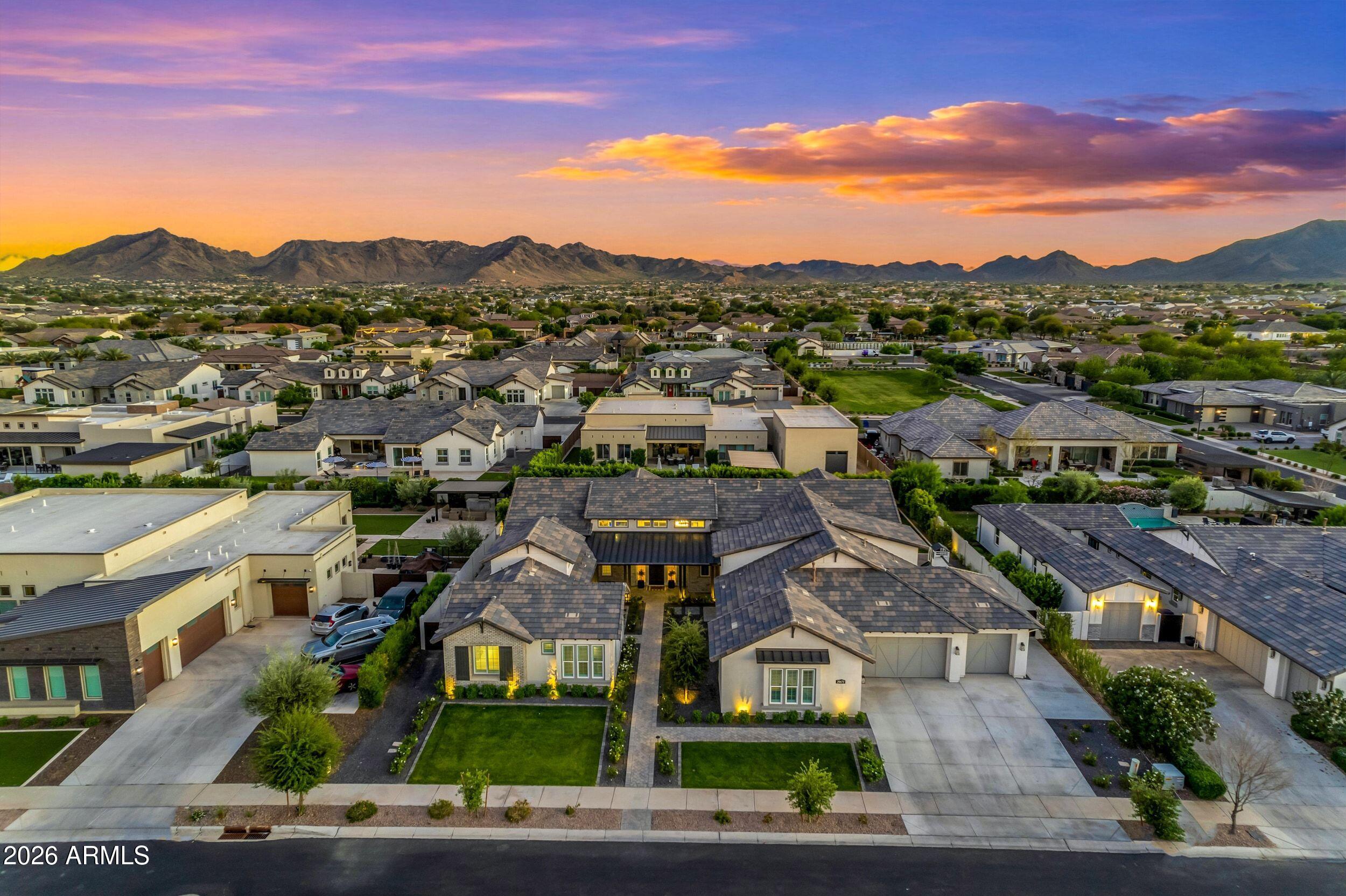 Located in the heart of Queen Creek, Arizona, a community often recognized as one of the best places to raise a family in the West, this exceptional home sits behind the gates of Whitewing at Whisper Ranch and offers timeless architectural character with thoughtful design and generous storage throughout.

The gourmet kitchen is both refined and functional, featuring KitchenAid appliances, quartz countertops, a spacious walk-in pantry, and custom built-ins with a beverage fridge in the breakfast nook. It flows effortlessly into the main living areas and out to the backyard through an expansive disappearing pocket slider, creating a seamless indoor outdoor experience that is ideal for both entertaining and everyday living.

The backyard is designed as a private retreat. A heated pool wit spillover spa, oversized Baja shelf, and a striking grotto create a true resort feel. The multisport court adds flexibility for recreation, while mature hedges provide privacy. The north south orientation brings in soft natural light throughout the day, and multiple covered patios offer comfortable spaces to relax and enjoy Arizona's year round outdoor lifestyle.

This home offers the largest floor plan in the community with five spacious bedrooms and four and a half bathrooms, including a private attached casita that works well for guests, extended family, or a flexible living space. The oversized four car garage features epoxy floors, high ceilings for additional storage, and is wired for an EV charger.

Residents of Whitewing at Whisper Ranch enjoy a private community center, parks, and a dog park, all within a gated setting just minutes from Queen Creek's shopping, dining, and entertainment.

A well designed home that offers space, privacy, and an elevated lifestyle in one of Queen Creek's most desirable communities.