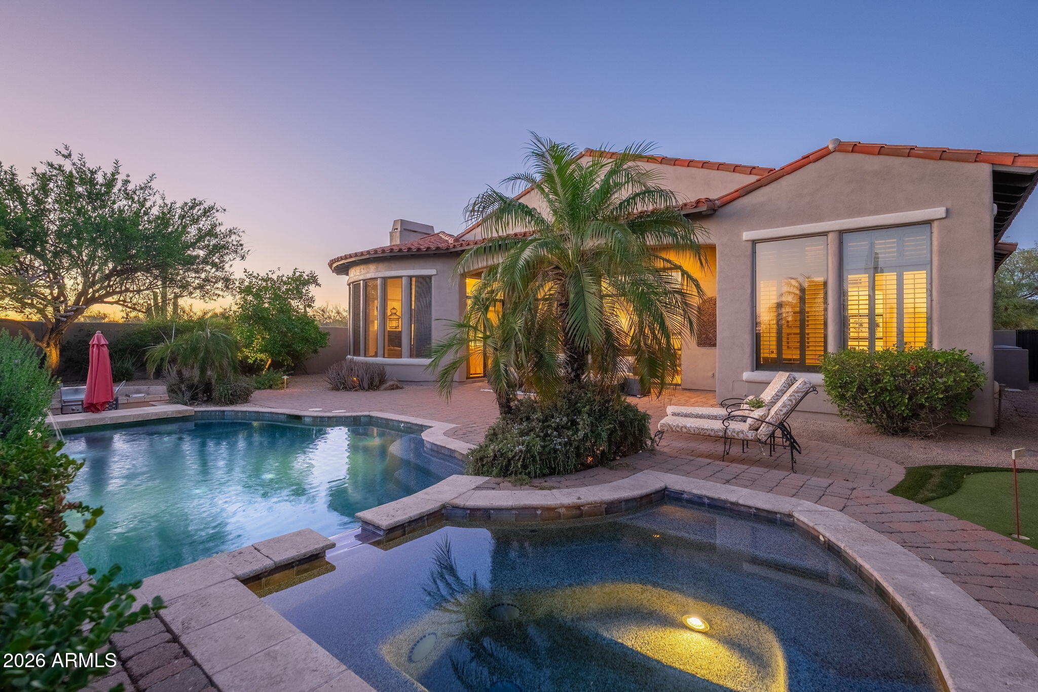 Welcome to guard-gated Grayhawk, where this stunning home delivers on every level. Backing to the Raptor golf course, the private backyard is an entertainer's dream -- heated pebble-tec pool and spa, swim-up bar with in-pool seating, and a built-in gas BBQ with infrared searing burner. The gated front courtyard, framed by the guest casita, sets a serene tone the moment you arrive -- a true outdoor Zen space that gives your guests both privacy and charm. Inside, the kitchen and master bathroom will stop you in your tracks. The chef's kitchen is loaded with stainless appliances, slab granite counters, a 6-burner gas cooktop, oversized island, and wine refrigerator. Three additional ensuite bedrooms plus a handsome private office with custom built-in cabinetry and desk round out a floor plan that simply works. Grayhawk living means months of incredible outdoor weather, and this backyard was built to take full advantage of every single day of it. Come see it for yourself -- this one lives up to the hype.
