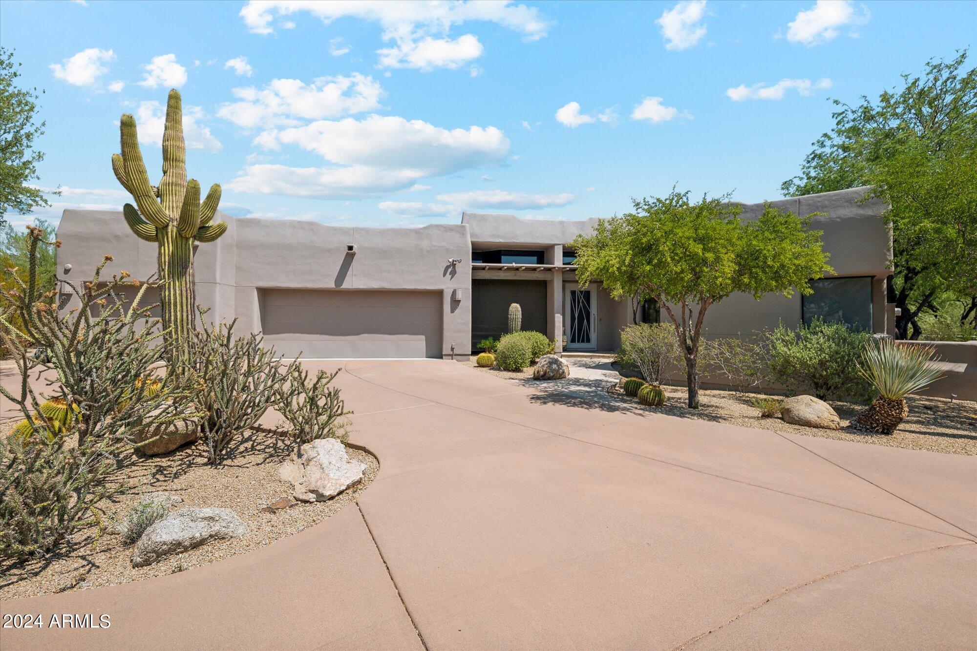 Step into elegance with this beautifully remodeled home featuring three significant upgrades. A long, private driveway welcomes you to an open-concept space with soaring 30 ft. ceilings, large windows, and sliding glass doors that frame breathtaking mountain views. The property includes two custom-designed water features and a spacious deck, perfect for entertaining. The Desert Highlands community offers unparalleled amenities, such as a Jack Nicklaus signature golf course, a comprehensive tennis center, pickleball courts, a fitness center, and a luxury country club.