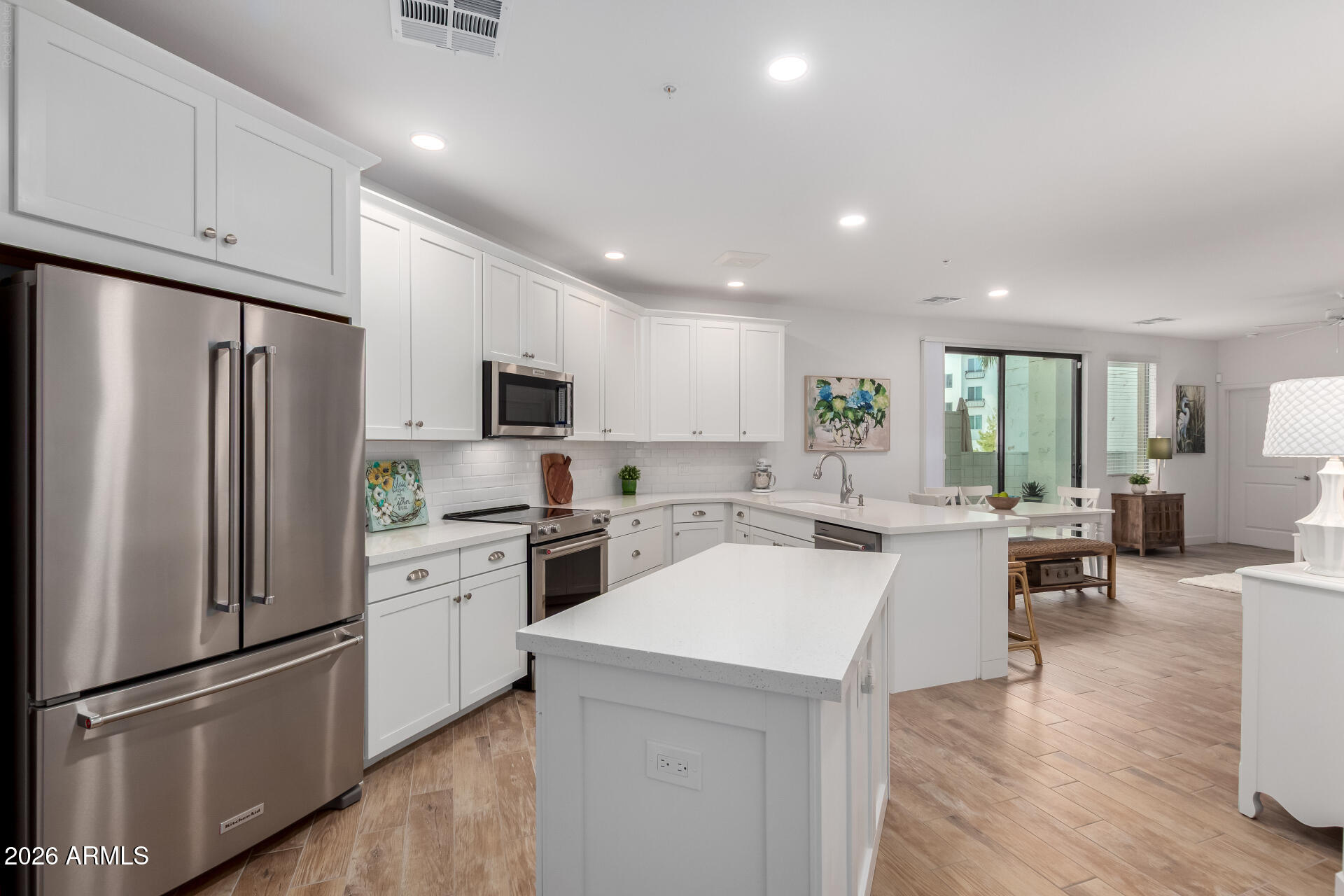 Luxury Lake Community Living in the Heart of Downtown Ocotillo!
Experience resort-style living in this beautifully upgraded condo, ideally located in the sought-after lake community in Downtown Ocotillo. Designed with both style and functionality in mind, this exceptional home features enhanced plank tile flooring throughout with no carpet, The gourmet kitchen is thoughtfully appointed with premium KitchenAid stainless steel appliances, including a counter-depth refrigerator with water and ice dispenser. Enjoy 42-inch full-overlay white shaker cabinetry with crown molding, pull-out shelves, integrated trash bins, a spacious pantry, and a generous drawer bank. The island and peninsula showcase charming board-and-batten detail plus designer tile backsplash and luxurious quartz countertops. The kitchen also features a Kohler cast iron undermount sink with an upgraded faucet, pull-down sprayer, and built-in soap dispenser. Quartz countertops continue into both bathrooms, each featuring sleek undermount sinks and upgraded lighting, plumbing fixtures, and hardware throughout.

The powder room offers an upgraded vanity with additional drawer storage, while the spacious primary bath includes an oversized vanity with a large storage drawer and plumbing in place for a second sink if desired. Relax in the spa-inspired walk-in shower featuring floor-to-ceiling tile, a built-in bench, niche, and frameless glass shower door.

Additional upgrades include:

Custom Classy Closets organization system in the primary suite
Full-size Whirlpool front-load washer and dryer
Pre-plumbed water softener loop
Epoxy-coated patio with hose bib
Private garage storage cage
Enjoy the ultimate lock-and-leave lifestyle with resort-style amenities and an unbeatable walkable location. Just steps from lakeside walking paths, restaurants, cafés, entertainment, and a day spa, this luxury community offers the perfect blend of convenience and relaxation.