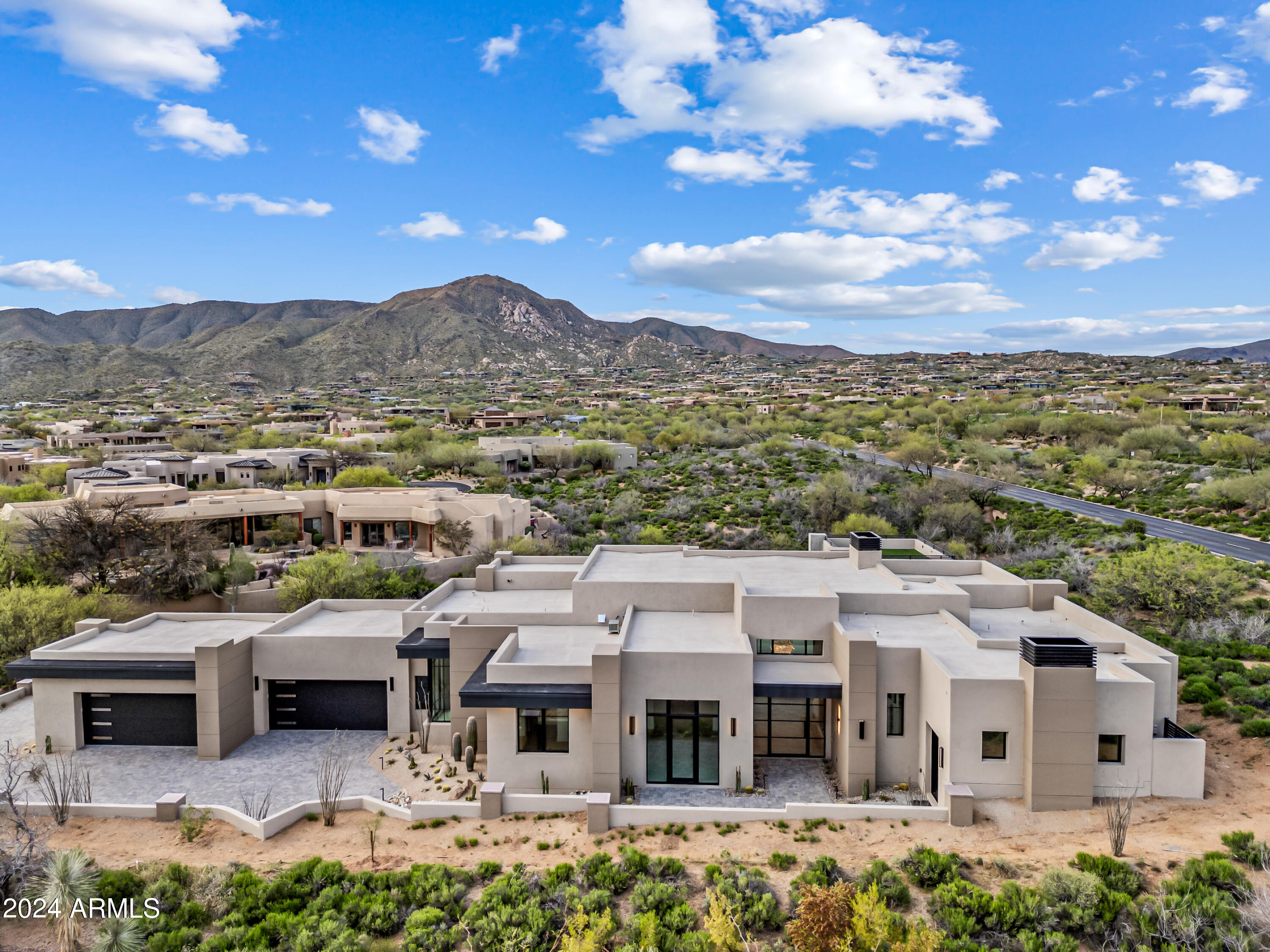 A rare and unique offering of a spacious NEW contemporary custom home, close to the cosmopolitan conveniences of affluent North Scottsdale, yet secreted within the pristine privacy of the Sonoran Desert behind the gates of the truly iconic upscale private golf community of Desert Mountain. An exquisite four bedroom with on suites hosts BREATHTAKING VIEWS, this contemporary yet timeless residence offers a spacious open floor plan with 5,502 sq ft featuring 15 ft ceilings, three fireplaces and an office or den. The superior craftsmanship is evident, showcasing meticulous attention to detail, top-tier amenities, exquisite modern finishes and a chef's kitchen. Step outside to discover a breathtaking outdoor oasis, featuring a captivating pool, a generous spa for ultimate relaxation, and multiple inviting seating areas. This al fresco retreat is an idyllic backdrop for intimate gatherings or grand-scale entertaining.  There is an ample four car garage for car lovers and plenty of storage.  A private one-bedroom casita suite features a second-floor view deck, offering panoramic of Tonto National Forest.