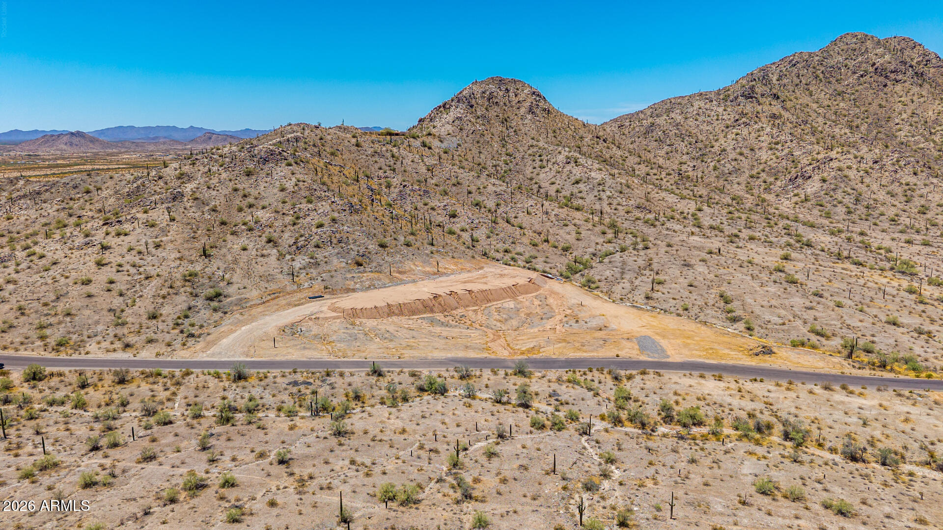 Exceptional 10.5 acre homesite just outside Maricopa offering mountain views, privacy, and the freedom to create your ideal desert estate, custom home or desert compound. Significant site work has already been completed, including a professionally engineered building pad with approximately 15,000 cubic yards of engineered fill and a completed driveway saving substantial time and expense. Power is nearby, with ample room for a custom home, guest house, horse facilities, RV garage, workshop, collector car storage, or recreational amenities. No HOA restrictions. Located just minutes from Apex Motor Club and a short drive to Maricopa conveniences. A rare opportunity for those seeking space, privacy, and freedom. Lot is made up of two, 5.27 acre lots, sold together only.