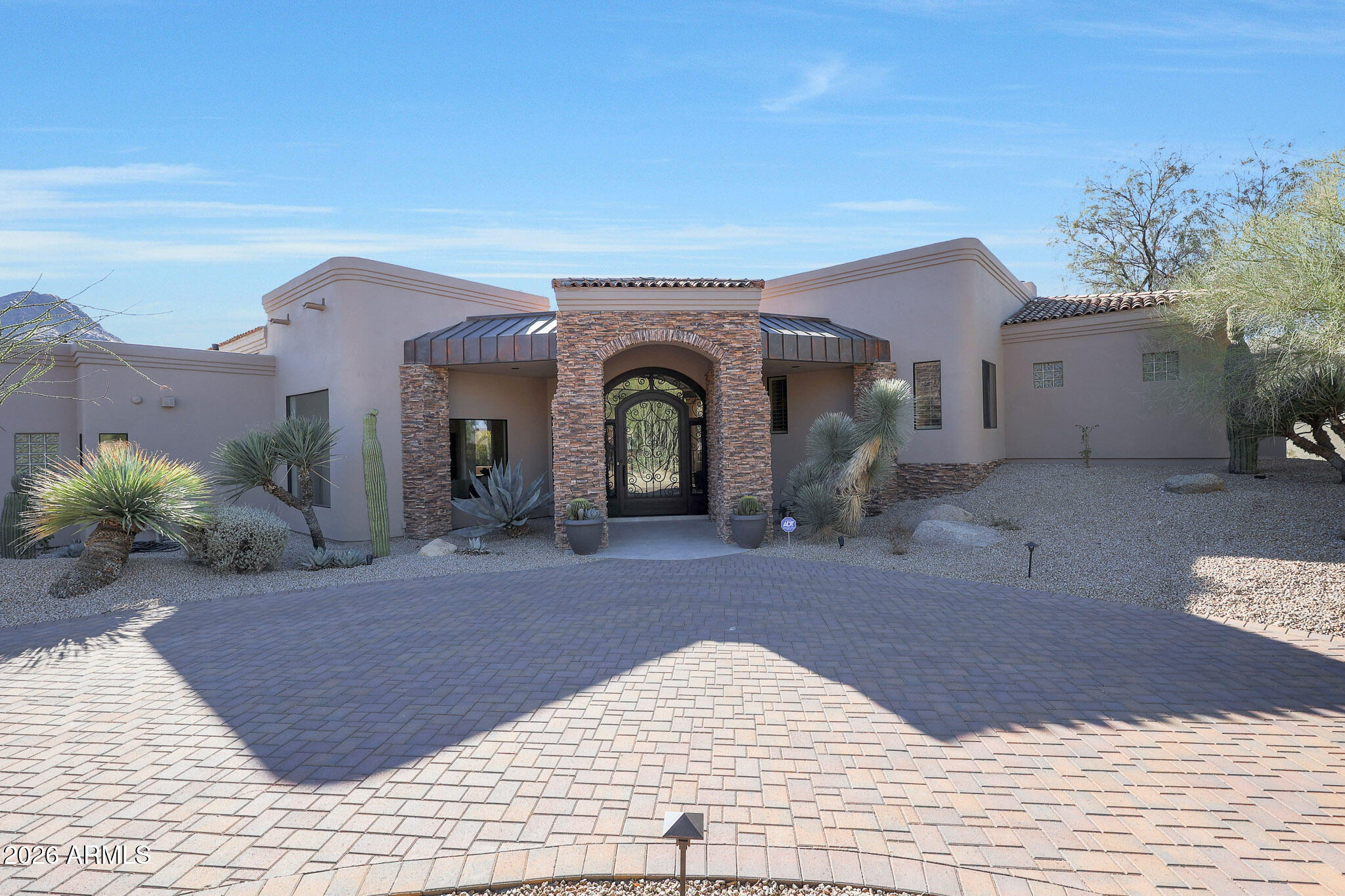 VIEWS, VIEWS, VIEWS! A must-see in person.
Experience a rare opportunity to own a fully remodeled 2024 luxury residence on one of Glenn Moor's most private and sought-after lots, showcasing breathtaking 360-degree views of Pinnacle Peak, Troon Mountain, and sparkling city lights. Tucked away at the end of a quiet cul-de-sac within the exclusive guard-gated Glenn Moor community, this exceptional home blends refined design, privacy, and unforgettable scenery. A grand circular driveway and lush desert landscaping create a striking first impression. Inside, soaring ceilings, dramatic stacked-stone fireplaces, and expansive floor-to-ceiling windows frame the surrounding natural beauty and fill the home with light. Designed for both everyday living and effortless entertaining, the gourmet kitchen features custom cabinetry, top-of-the-line appliances, a marble backsplash, and an oversized island.

Outdoor living is equally impressive, highlighted by a brand-new custom infinity-edge pool and all-new landscaping that enhance both functionality and the property's stunning backdrop. Expansive glass sliding doors open to multi-level patios designed for relaxing, entertaining, and taking in uninterrupted mountain and golf course views.

The luxurious primary suite offers a private retreat, complete with a sitting area and a spa-inspired ensuite featuring a freestanding soaking tub, new steam shower, dual vanities, and a spacious walk-in closet. Additional upgrades include European white oak plank flooring, a new foam and tile roof with a 10-year warranty, and Lutron touch outlets, switches, and smart Wi-Fi throughout.

An oversized 3-car garage with built-in storage and generous parking completes the home. With access to Troon's renowned golf, tennis, and pickleball amenities, this property offers an exceptional lifestyle in the heart of North Scottsdale.