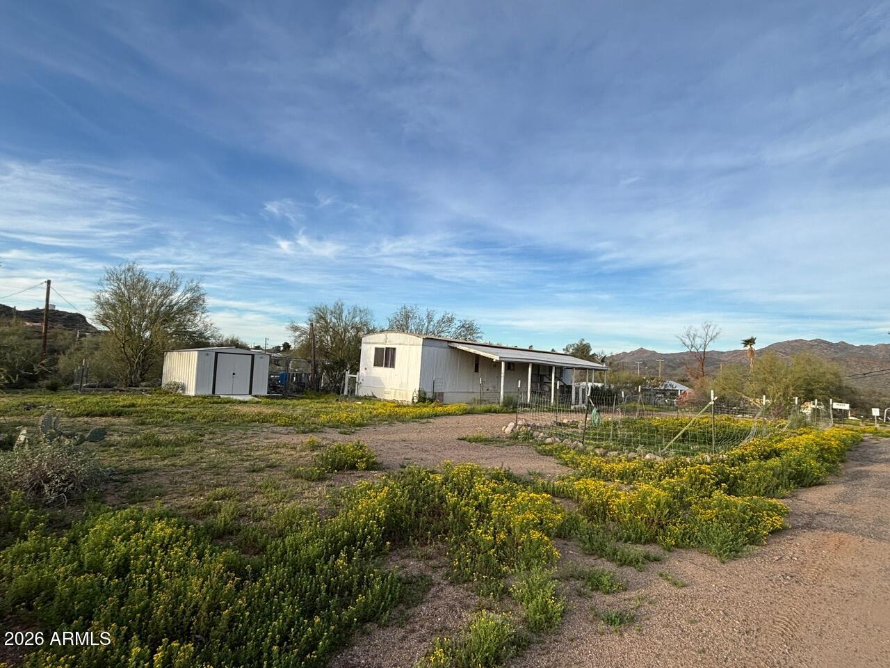 .76 of an acre that has stunning mountain views, a private well and is also on private water company.  Manufactured home is a 1979 unaffixed single wide(still has title) in need of repair.  Electricity will not be turned on as it is non-functional and in need of being upgraded.