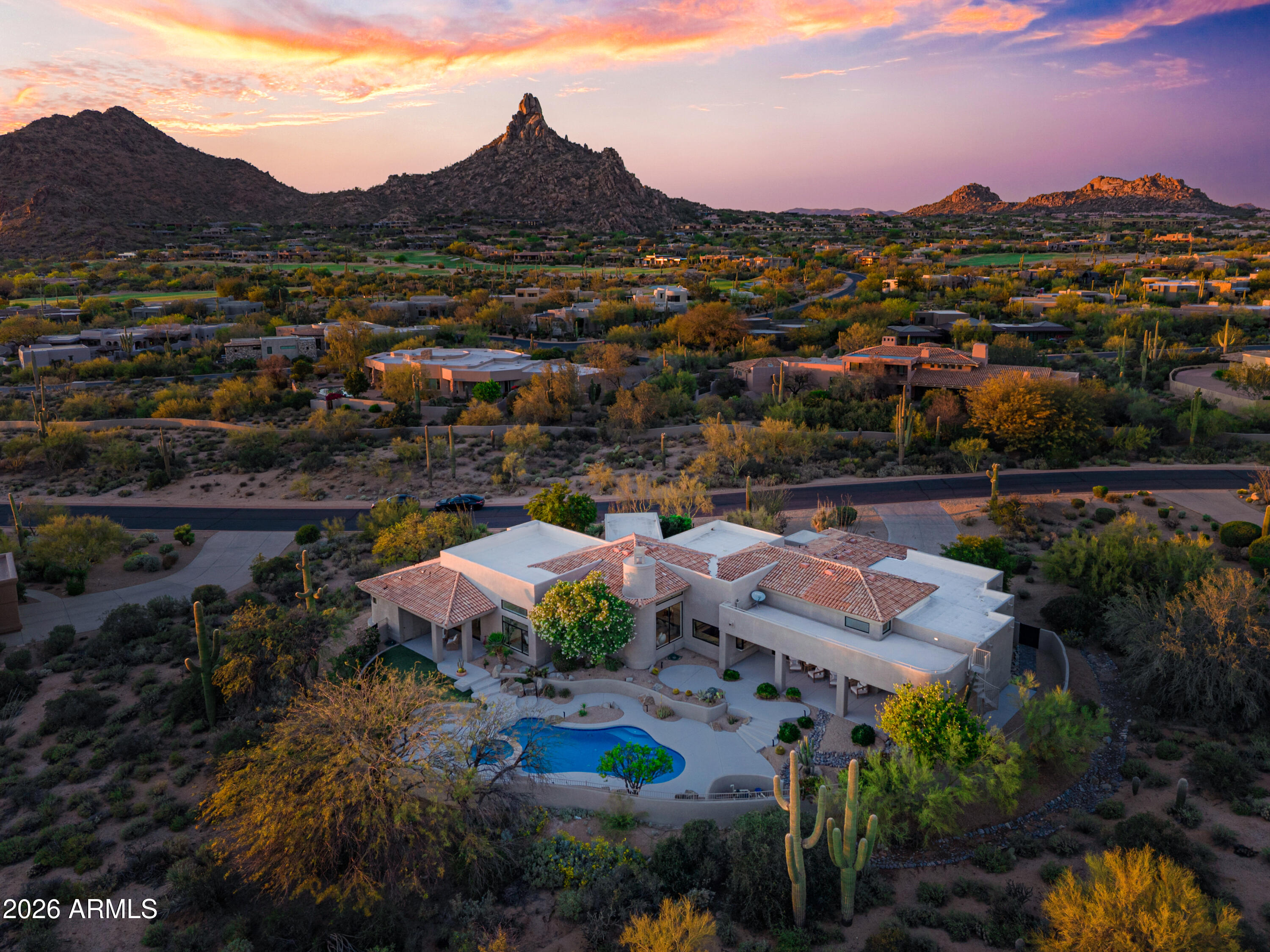 Experience elevated desert living in this meticulously reimagined home, located in the prestigious gated community of Eagles Glen. Nestled on a generous lot of nearly an acre, this home blends contemporary sophistication and timeless Sonoran beauty, featuring those Arizona sunsets and city light views from the south-facing back yard. Panoramic views of Pinnacle Peak to the front and Troon Mountain to the east that you can see from the sun drenched sparkling pool. 

The remodeled interior is sophisticated and seamless. Once you enter the glass, iron pivot door you will find a bright, airy open floor plan defined by engineered hardwood flooring, modernized smooth-textured walls, and custom ceiling beams in the family room. A sunny glass-walled office sitting just off the main living room. The chef's kitchen and entertainer's bar are the heart of the home. Featuring slim-shaker cabinetry, a custom hidden range hood, and granite countertops that extend into a full-height backsplash. Premium appliance package includes a full suite of GE Monogram appliances, including a 48" gas stove and 42" built-in refrigerator. The bar is perfect for hosting, it features a unique folding window for indoor-outdoor flow and a GE Profile beverage center.

The primary wing is a private sanctuary featuring new sliding doors to the patio. The spa-like bath boasts quartz countertops, designer sconces, and a stackable LG washer/dryer located right in the primary closet for ultimate convenience.