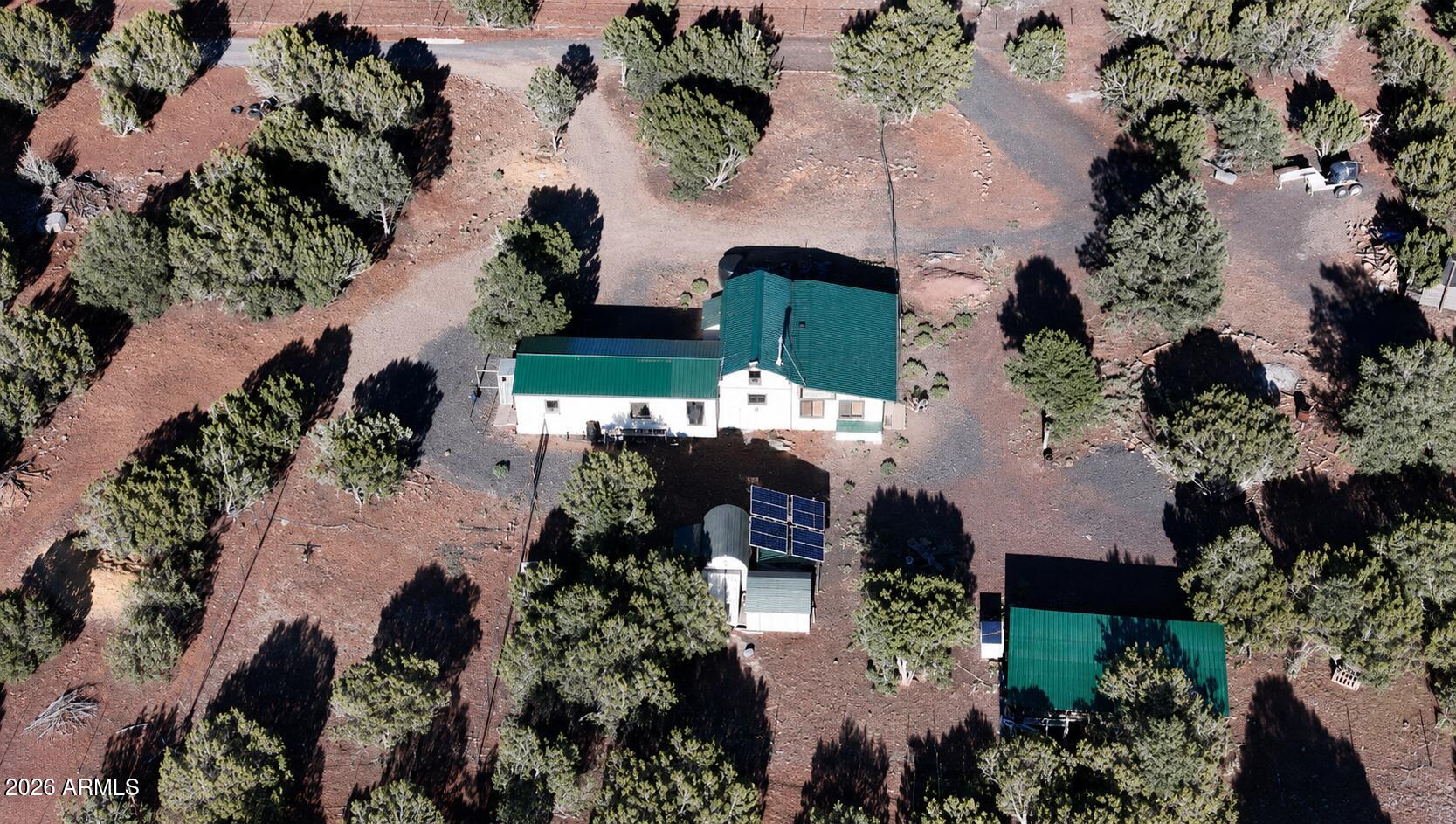 Don't miss this rare opportunity to own a 6-acre off-grid property that's already set up and ready for you to finish the ''lil'' touches to make it yours.  This is the lifestyle everyone is looking for--privacy, self-sufficiency, and room to grow. Created by the seller with Graceland and Apache County permits, the property includes a permitted septic system, solar power, and a water storage tank --giving you a strong head start on off-grid living. Power is nearby, offering the option to connect to the grid if desired. The home offers just over 1,400 sq. ft. and features a kitchen with refrigerator and stove, a comfortable bedroom, a spacious living area, and an adorable bathroom with a tub/shower combo, toilet, sink, and storage. Outside, the property includes a covered lien-to for parking, partial fencing, a chicken coop, and two storage sheds--perfect for homesteading or additional storage needs.

If you've been dreaming of off-grid living without starting from scratch--but still want the option for on-grid convenience--this property is ready for you to step in and make it your own on 6 beautiful acres.