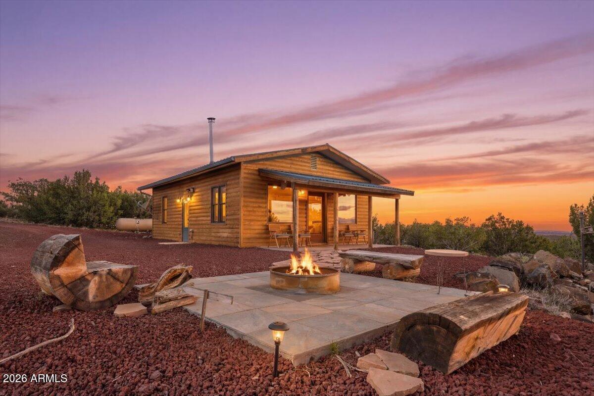SELLER CARRY! Charming 2 bed, 1bath, 816 sq ft log sided home, on 2 acres offering true off grid living.  State of the art solar system that has more than enough power for this home. 2500 gal water tank and 500 gal propane tank. Vaulted ceilings and surround sound both inside and out. FULLY FURNISHED! This cozy retreat features a warm woodstove, efficient layout, and stunning mountain views from every angle. Kitchen is fully equipped with island, gas stove, microwave, dishwasher and granite counters. Enjoy peaceful seclusion, sustainable living, and a turnkey setup perfect for a getaway, full time residence, or rental. A rare chance to own a self sufficient mountain escape with comfort, character, and unmatched natural beauty. Additional 2 acres, tiny log home and sauna as a package dea