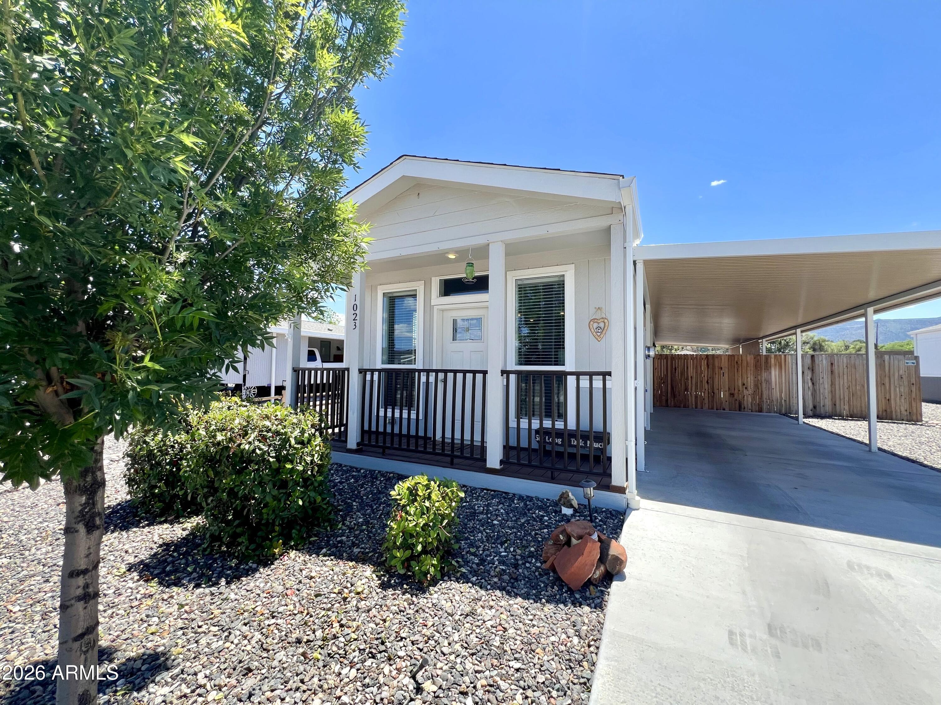 Welcome to Verde Ranch Estates...an all-ages, gated community in the heart of Camp Verde! Built in 2022, this 2-bedroom, 2-bathroom, single-wide manufactured home offers 920 sq ft of modern, comfortable living with an inviting outdoor space designed to enjoy the relaxed Verde Valley lifestyle. 

From the moment you arrive, you'll appreciate the welcoming curb appeal, and the open-concept living, dining, and kitchen area that's filled with natural light, creating a bright and airy atmosphere that feels both cozy and functional. Whether you're entertaining guests or enjoying a quiet evening at home, the layout offers an easy flow for everyday living. The kitchen is thoughtfully designed with stainless steel appliances, ample cabinetry, generous counter space, and a practical layout that makes meal prep and hosting simple and enjoyable. The primary bedroom and guest bedroom are positioned toward the back of the home for added privacy, while both bathrooms are tastefully finished and conveniently located. 

Step outside and discover a backyard retreat that truly sets this property apart. The fully fenced outdoor space has been carefully landscaped to create a peaceful and private setting, complete with a paver patio, covered patio area with sunshades, soothing water fountain, charming fish pond, mature plants and shade tree, raised garden bed, and a Tuff shed with a GFI power outlet to use as a workshop, or for additional storage. Whether you enjoy gardening, relaxing outdoors, or spending time with family and friends, this backyard offers the perfect space to unwind and enjoy Arizona living year-round. 

Residents of Verde Ranch Estates enjoy access to outstanding community amenities, including a modern clubhouse, resort-style pool and spa, fitness center, pickleball courts, playground, community gathering spaces, and much more - creating a vibrant and active lifestyle for residents of all ages. 

Ideally located in the scenic Verde Valley, this home also places you near some of Northern Arizona's most popular attractions and outdoor destinations. Enjoy easy access to hiking, off-road adventures, wineries, golf courses, and nearby destinations such as Sedona and the Verde River recreation areas. Whether you're looking for outdoor adventure, local dining, shopping, or simply taking in the beautiful Arizona scenery, this location offers something for everyone. 

This home offers an exceptional opportunity for first-time home buyers, seasonal residents, retirees, or anyone seeking affordable, low-maintenance living in a newer home with exceptional outdoor charm. Whether you're seeking outdoor adventure, cultural experiences, or relaxed small-town living, this home puts it all within easy reach - making everyday living feel like a getaway in the heart of the Verde Valley.