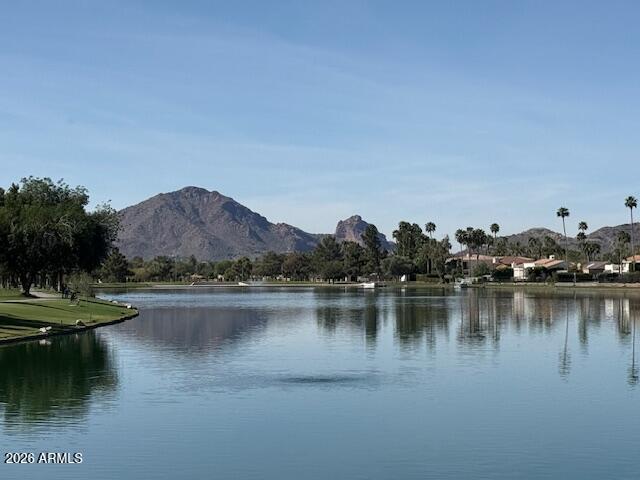 EXQUISITE Lakefront home in the exclusive gated community of Las Palomas.  This exceptional home has been impeccably remodeled with all the finest finishes of a custom-built home.  12' soaring ceilings with gorgeous views of Camelback Mountain from the entire glass backside of the home.  Downstairs boasts 3 beds/3 baths. Upstairs features a living room, bedroom and separate kitchen perfect for guests. Featuring Poplar White Quartzite counters, Sub Zero, Wolf, Cove appliances, a Butler's pantry, all marble baths, hardwood flooring, RH lighting, and expansive cabinetry and closets. Showcasing designer finishes throughout and top of the line features with no detail overlooked.  Limestone pavers in front entry as well as on the expansive covered outdoor patio. This home is STUNNING!!