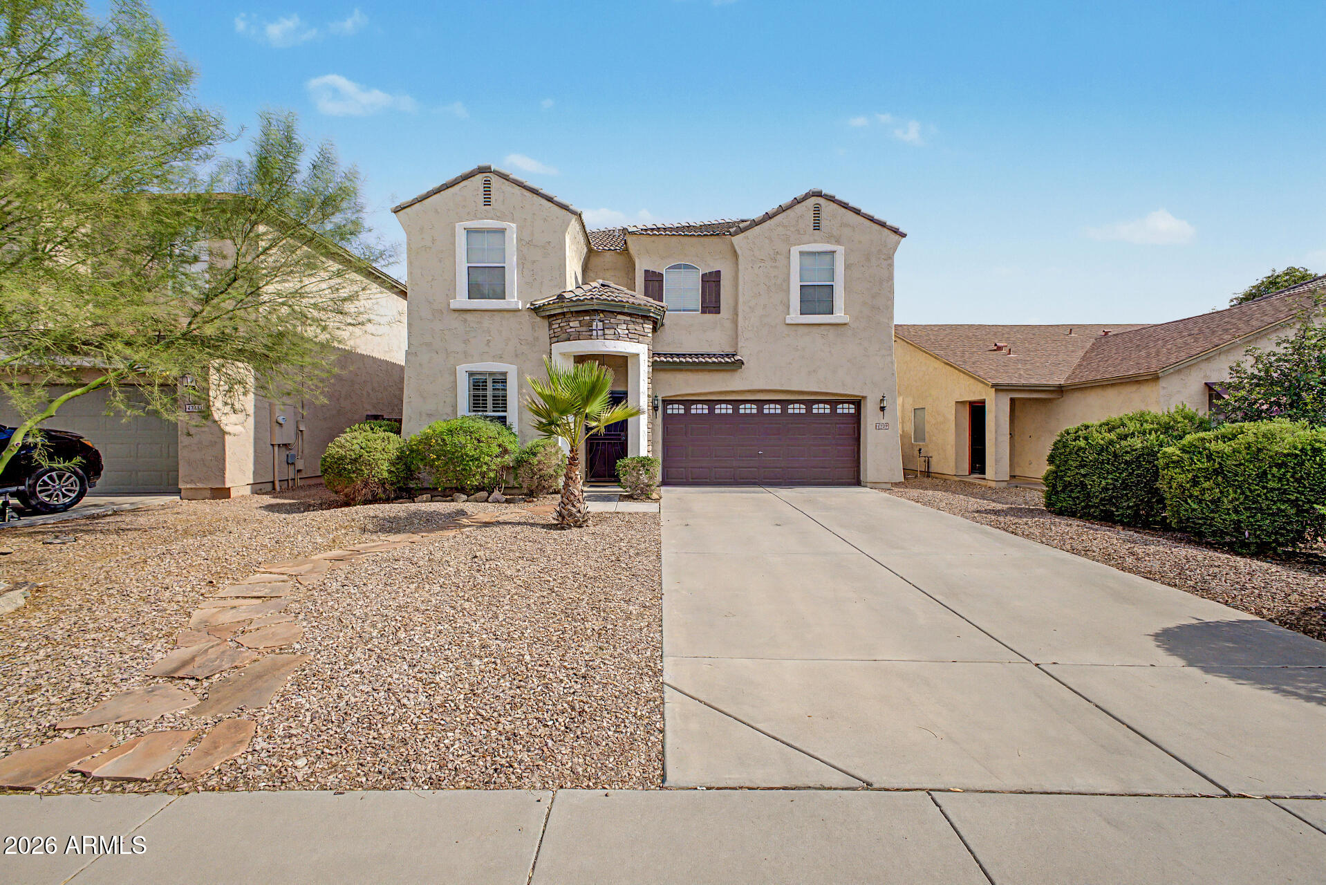 Welcome to this beautifully upgraded home in the highly desirable Villages at Castlegate! Perfectly situated on a premium lot backing to a common area, this stunning property features a sparkling Pebble Tec pool and offers the ideal blend of comfort, style, and privacy. The attractive stone elevation and security screen door create excellent curb appeal. Inside, you'll find a versatile den with laminate wood flooring, perfect for a home office or flex space. The open-concept kitchen overlooks the dining and living areas and features granite countertops, a tile backsplash, stainless steel appliances, a pantry, peninsula island with breakfast bar, and upgraded nickel faucet. Upstairs, a spacious loft with a built-in desk and cabinetry provides the perfect space for work, study, or a second living area. The primary suite offers double-door entry, dual walk-in closets, and an ensuite bath complete with a granite vanity, full shower, and private water closet. Two additional bedrooms share a full bath with a granite vanity and decorative mirror. The laundry room is fully equipped with a washer and dryer for added convenience. Additional upgrades include an epoxy-coated garage floor, side yard access door, and a water softener system.
Step outside to your own backyard oasis featuring a covered patio, low-maintenance artificial turf, a Pebble Tec pool with Baja step, in-floor cleaning system, and peaceful views of the common area behind the home. This exceptional property is truly move-in ready and offers everything you need to enjoy Arizona living at its finest.