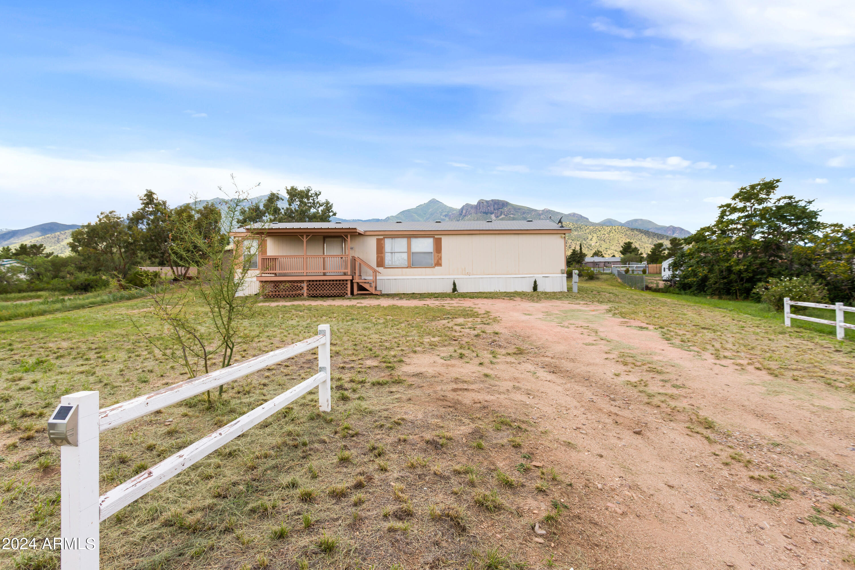 Wake up everyday in your new home that boasts outstanding views of the Huachuca Mountains. Sitting on just about an acre of land, this charming home has 3 bedrooms and 2 bathrooms in a split floorplan layout. A spacious living room leads you into a dining area as well as a kitchen with many cabinets and ample counter top space. In your backyard are two newer sheds that will stay with the property, as well as a platform where the seller loved to enjoy the night skies and awesome views.