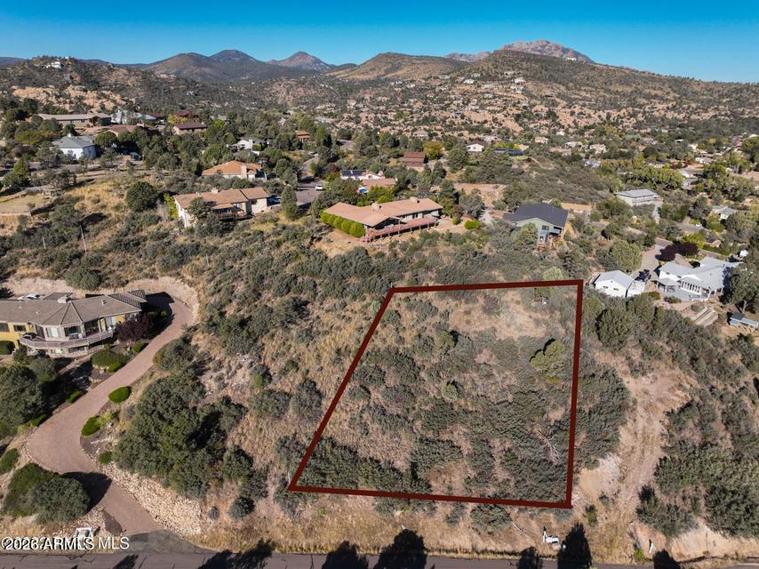 Discover an exceptional lot situated in the heart of Prescott! This .51-acre property is the perfect location for your dream home. Enjoy easy access from Pleasant Valley Rd, and rest assured that utilities are conveniently located nearby. You will be WOWED by breathtaking views of Bill Williams Mtn, San Francisco Peaks, the iconic Granite Dells, and the Mingus Mountains. This prime location puts you within close proximity to everything Prescott has to offer, including Dignity Health Hospital, Embry-Riddle Aeronautical University, Prescott High School, an array of shopping destinations, and the vibrant heart of Downtown Prescott. The surrounding area boasts an impressive collection of custom homes, ensuring a unique and desirable neighborhood where you won't find any ordinary, cookie-cutter houses. No HOA!