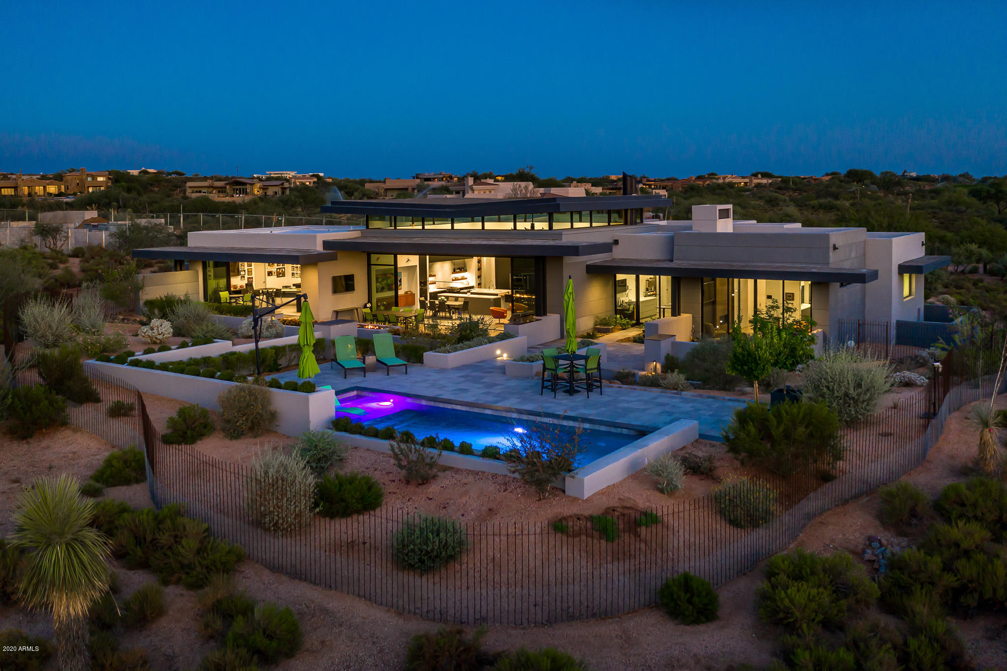 Architecturally Stunning New Contemporary by the Renowned Firm -Phoenix Architecture. Walls of glass bring natural light into play throughout the day and colorful Western sunsets throughout the year.  Open floor plan with warmth, character and whimsy. State of the art technology. Main house has large master, two offices, large pantry, elegant powder room, two guest suites, large laundry/wrapping area and three car garage with great storage. Guest house is equipped with a bar and excellent for a ''man cave'' or game room, or large guest suite with full bath. Excellent views of Apache Peak, Apache Golf Course's Par 5 # 16, and wonderful privacy. Some furniture may be available by separate agreement, as is the golf membership to the Desert Mountain Club.