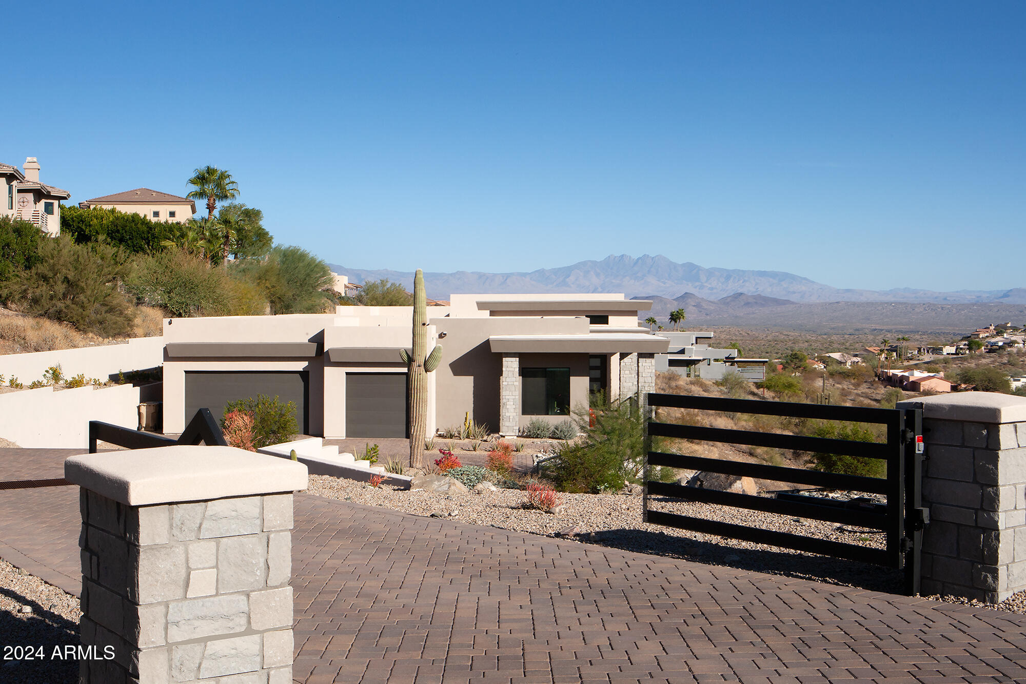 Experience luxury living at its finest in this newly completed (2023), contemporary Southwest estate situated on 2.06 acres of pristine, privately gated land. This stunning property boasts breathtaking views of Four Peaks, Redrock Mountain, and the Superstition Mountains.  Designed with an open, view-oriented layout, this home features expansive 8-foot interior doors and 16' x 10' stacking sliding doors that seamlessly connect the indoors with the stunning outdoor spaces, including a private pool and spa and Sonos sound system. The grand Great Room is highlighted by a 60'' electric fireplace, creating an inviting atmosphere. The gourmet kitchen is a chef's dream, with a spacious 10' island, shaker-style cabinetry reaching 10' in height, and Frigidaire Pro Series stainless steel appliances including a full-size refrigerator and freezer.  The 99-bottle wine captain adds a touch of elegance to the space.  This home includes a large den, two fully en-suite bedrooms, and a separate Casita for ultimate privacy and comfort. The luxurious primary suite offers a generous walk-in shower, a beautiful soaking tub, and an expansive 9x13' walk-in closet with custom shelving.  The oversized 5-car garage features 10-12' ceilings, offering ample space for vehicles and storage.  New construction by Harr Family Homes, master builders with over four decades of experience.  Live in unparalleled comfort, style, and privacy in this exceptional home. There is "No HOA"