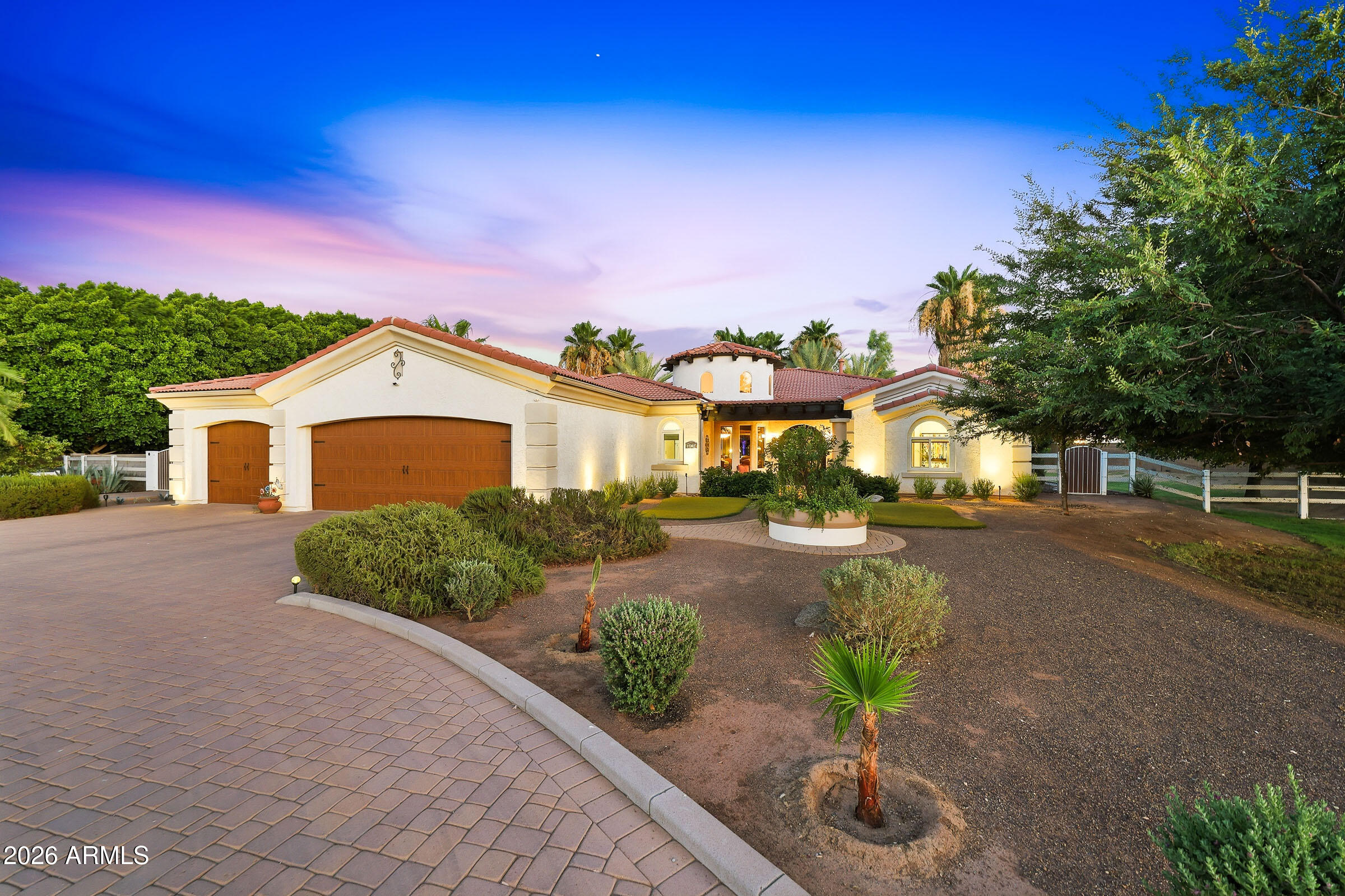 Custom built resort style estate on a fully fenced irrigated acre with no HOA and over 3000 square feet of livable space.  Experience the perfect blend of luxury, comfort and outdoor living in this one-of-a-kind property offering privacy, flexibility and amenities todays buyer's demand.  The backyard is a true resort-style retreat featuring a 25,000-gallon pool and spa, surrounded by majestic date palms, professional lighting system and an expansive paver hardscape. Enjoy year around outdoor living with a gazebo bar, outdoor kitchen, misting system, heaters, shade features with ample space to accommodate large gatherings.  The beautifully Spanish style home complete with a detached casita, offers versatile living for guests & multi-generational living.  Inside the main home showcases ri wood flooring, custom tile work, soaring 10-foot ceilings and elegant 8-foot alder doors throughout creating an inviting balance of sophistication and everyday comfort.  The remodeled gourmet kitchen features a waterfall edge quartz counter tops, abundant custom alder cabinetry, 48' refrigerator, gas cook top and double ovens.  The Luxurious primary suite with a spacious walk-in closet, spa-inspired two-person shower and dual vanities.  Additional highlights include an oversized 3 car garage, a separate casita with garage/workshop, epoxy floors, built in storage, security system and solar lease for energy efficiency.  Located only 1 mile from the Loop 303 and only 5 miles from the rapidly growing Prasada Entertainment district while still enjoying the tranquility & space of country living