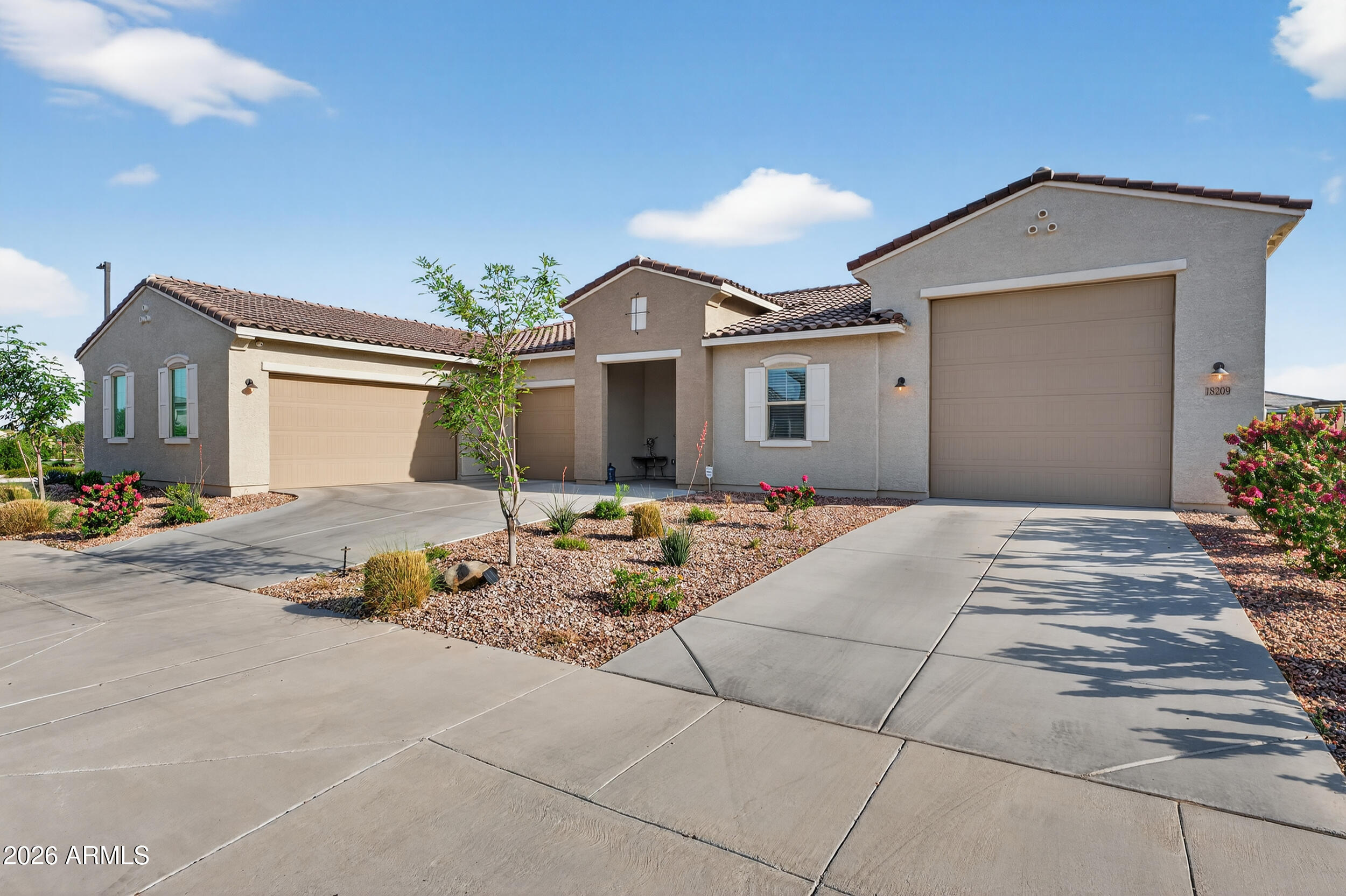 Welcome to Azure Canyon, where functionality meets flexibility in one of the most sought after layouts in the area. This 2023 built home offers a spacious open concept design with a large kitchen island that flows seamlessly into the main living area, creating the perfect space for everyday living and entertaining. What truly sets this home apart is the oversized RV garage that has been thoughtfully converted into a fully functional bonus space complete with its own AC unit, kitchenette, and full bathroom. Whether you're looking for a game room, guest suite, home gym, or multi generational setup, this space offers endless possibilities. The split floor plan is designed with both privacy and convenience in mind, with all bedrooms offering direct bathroom access. One of the secondary bedroom features its own private bathroom, functioning similarly to a second primary suite and ideal for guests or extended living arrangements. A separate bonus living area between the secondary bedrooms adds even more flexibility as a media room, playroom, or home office. The backyard is clean and low maintenance with plenty of room to design your ideal outdoor setup. Located in a growing West Valley community with convenient access to shopping, dining, and freeway access, this home offers the opportunity to move right in without the wait of new construction.