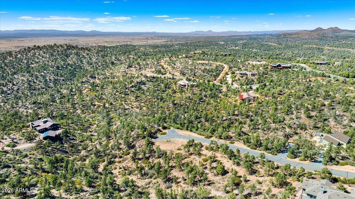 Premier 2.12 acre estate lot located at the end of a cul-de-sac, showcasing stunning views and privacy.  This homesite community features NO HOA, paved roads and a private water and sewer company with underground utilities.  The adjacent lot is also for sale which when combined would be over 4 acres at the end of this private cul-de-sac.  Cool summer weather, only 13 miles from Prescott and beautiful views make this an excellent choice of your new home.