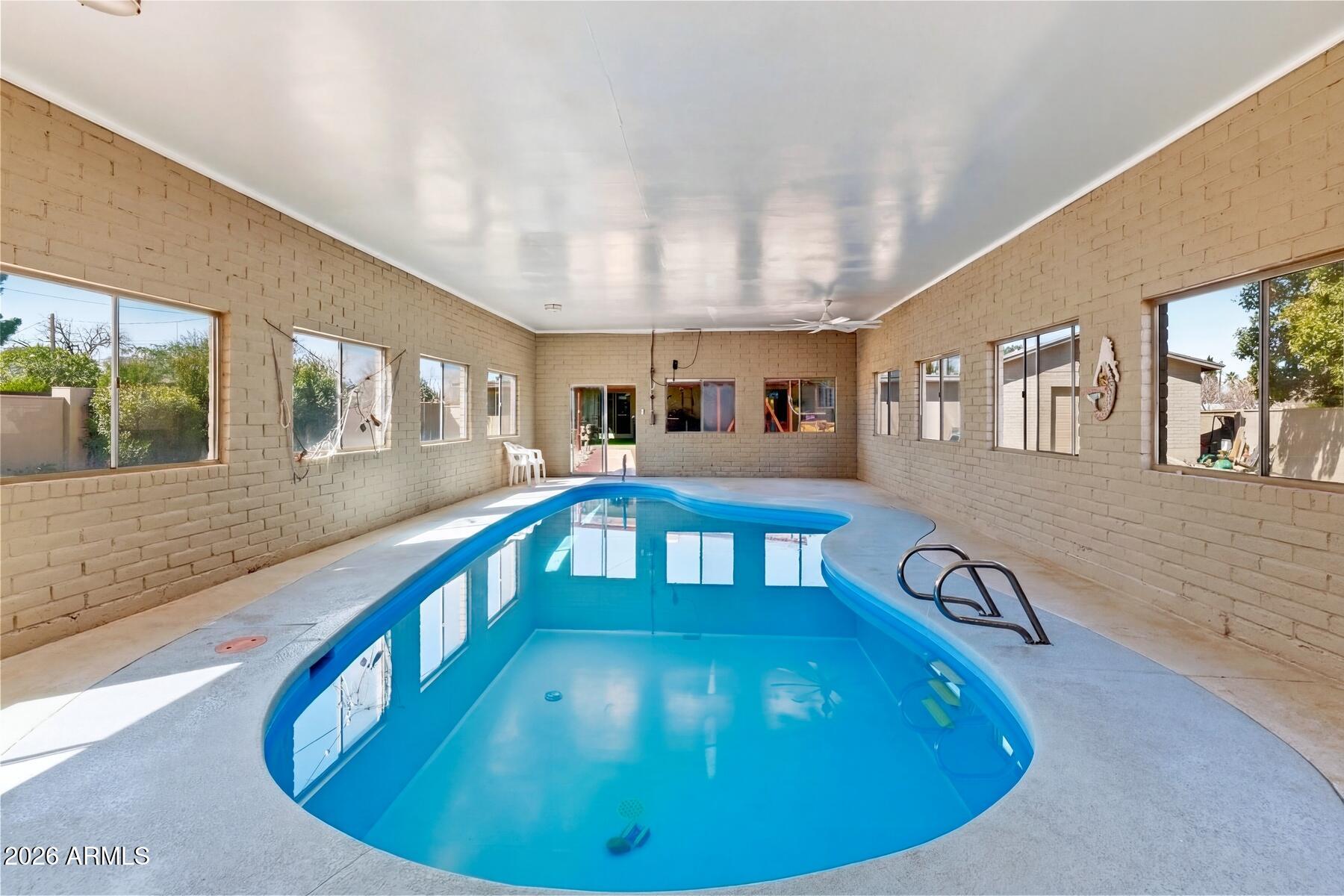 Updated and Maintained Beautiful 3 Bed 2 Bath home on over a 1/2 Acre in Sierra Vista centrally located to all of town.  This home features a private swimming pool in it's own separate building on the property as well as 2 garages one double car and one single car drive though.  That allows you to access the back yard.  You fall in love with this home that offers you the most in your own private seclusion.