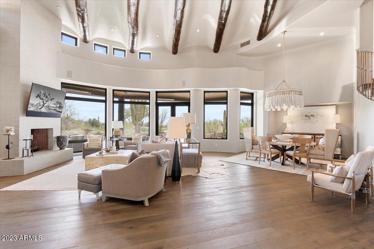 Situated on the 11th tee boxes of the Country Club at DC Ranch golf course, this beautifully maintained and updated Nance custom offers stunning mountain, golf course and city light views and a sunny south-facing backyard. A long meandering driveway provides the ultimate private setting. This warm, comfortable and open floorplan lives like a single level home with only a den/bonus room with bathroom, and breathtaking city/sunset views on the 2nd floor. The tranquil backyard offers an imposing mountain backdrop, golf course and sunset views, and was completely renovated in 2021 to include a new pool, spa, gas firepit, paver stone pool deck and patio surface, built in BBQ, and landscaping, as well as a misting system and built-in heaters at the covered patio. A Crestron system operates lighting, audio/visual, interior window shades and thermostats. Many cosmetic and mechanical updates have been completed in the past few years.