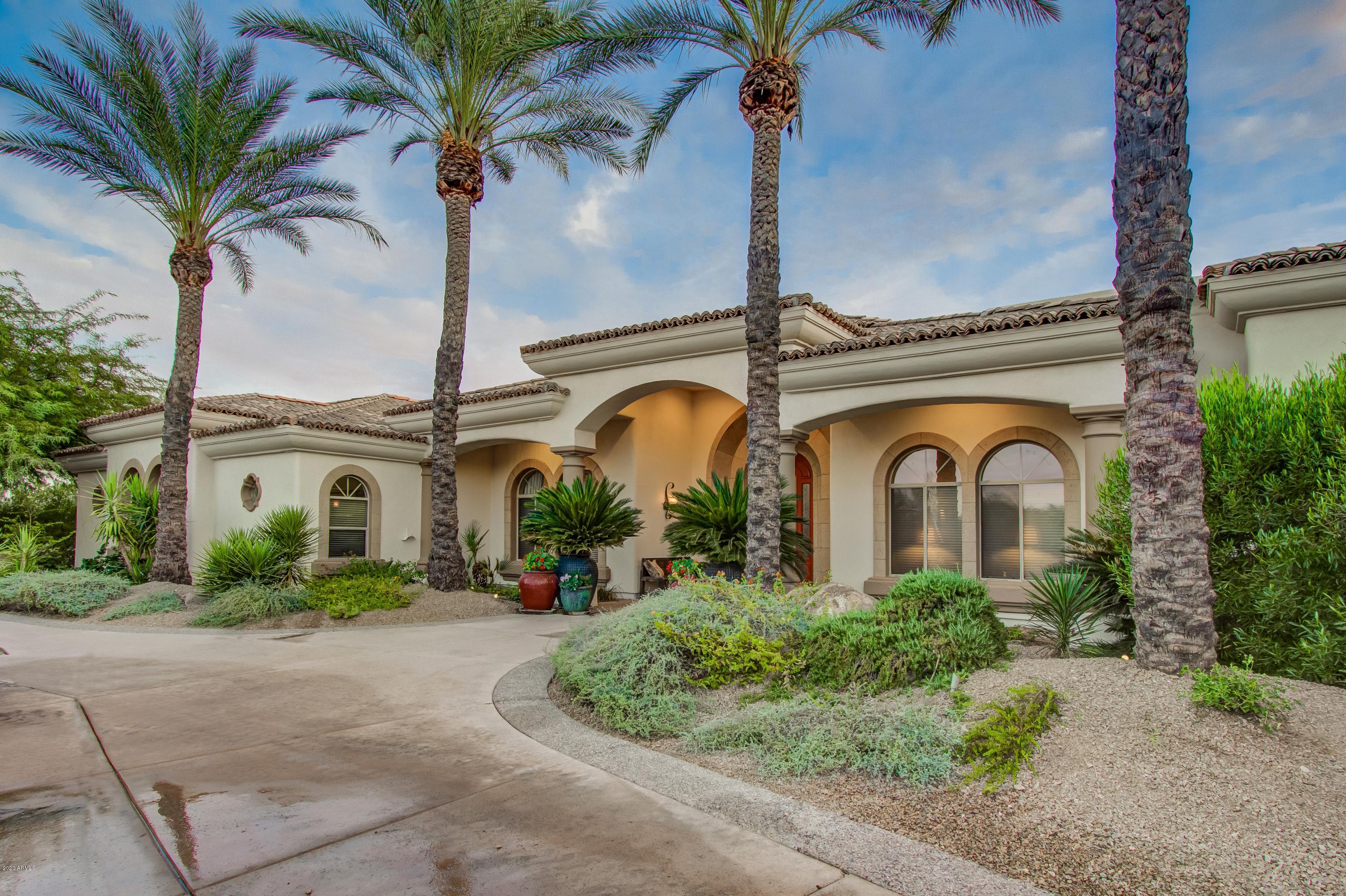 Heart of Paradise Valley this home has an open floor plan, family room offers a gas fireplace, bar area that opens to the gourmet kitchen w/ large center island. 2 dishwashers, Subzero. Butlers pantry with lots of storage. Large & airy master suite has cantera stone gas fireplace,  master bath features dual walk-in showers & bathrooms and dual closets, coffee bar w/ refrig. Bath looks out into a beautiful court yard. All secondary bedrooms are ensuite, generous in size & split from the Master. Home is light & bright with quality workmanship and plenty of storage closets and cabinetry. South facing Resort style backyard features a cobalt blue glass tiles in the pool & spa. 900 sqft of covered patio, lush green landscaping. Bonus room just off of the 3 car garage for exercise or office.