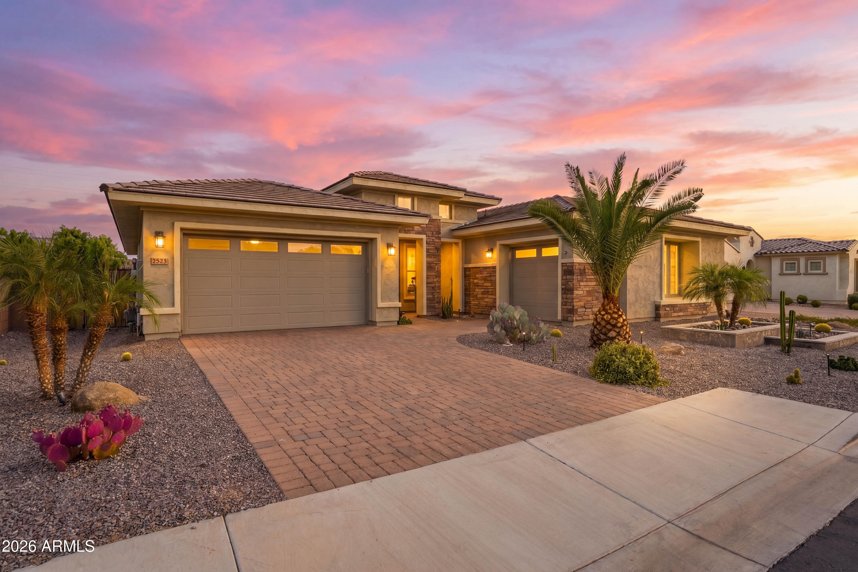 Located in an exclusive gated community, this luxury residence offers refined modern living near premier dining, shopping, golf, and entertainment. Built in 2021, the home presents like new with pristine finishes and high-end appliances. The open-concept floor plan features expansive living spaces, abundant natural light, and seamless indoor-outdoor flow through oversized glass slider doors. The home includes 4 spacious bedrooms, each with a private en-suite bath and walk-in closet. The resort-style backyard features a pool and spa with electric heat pump and gas heater, Baja step, water features, putting green, and expansive covered patio. Additional highlights include a 3-car garage, split floorplan, stunning landscaping, and an exceptional Gilbert location. This home is also complete with a tankless water heater, soft water system, reverse osmosis, and an abundance of storage space. You'll also find designer finishes throughout and an unparalleled combination of luxury, functionality, and location. Situated next to Gilbert Christian Schools and a short distance from San Tan Village, this quiet neighborhood stays diligently maintained by the HOA and its residents. Having never been used as a primary residence, this is a rare opportunity to own a meticulously maintained, essentially brand-new home in one of Gilbert's most desirable gated communities.