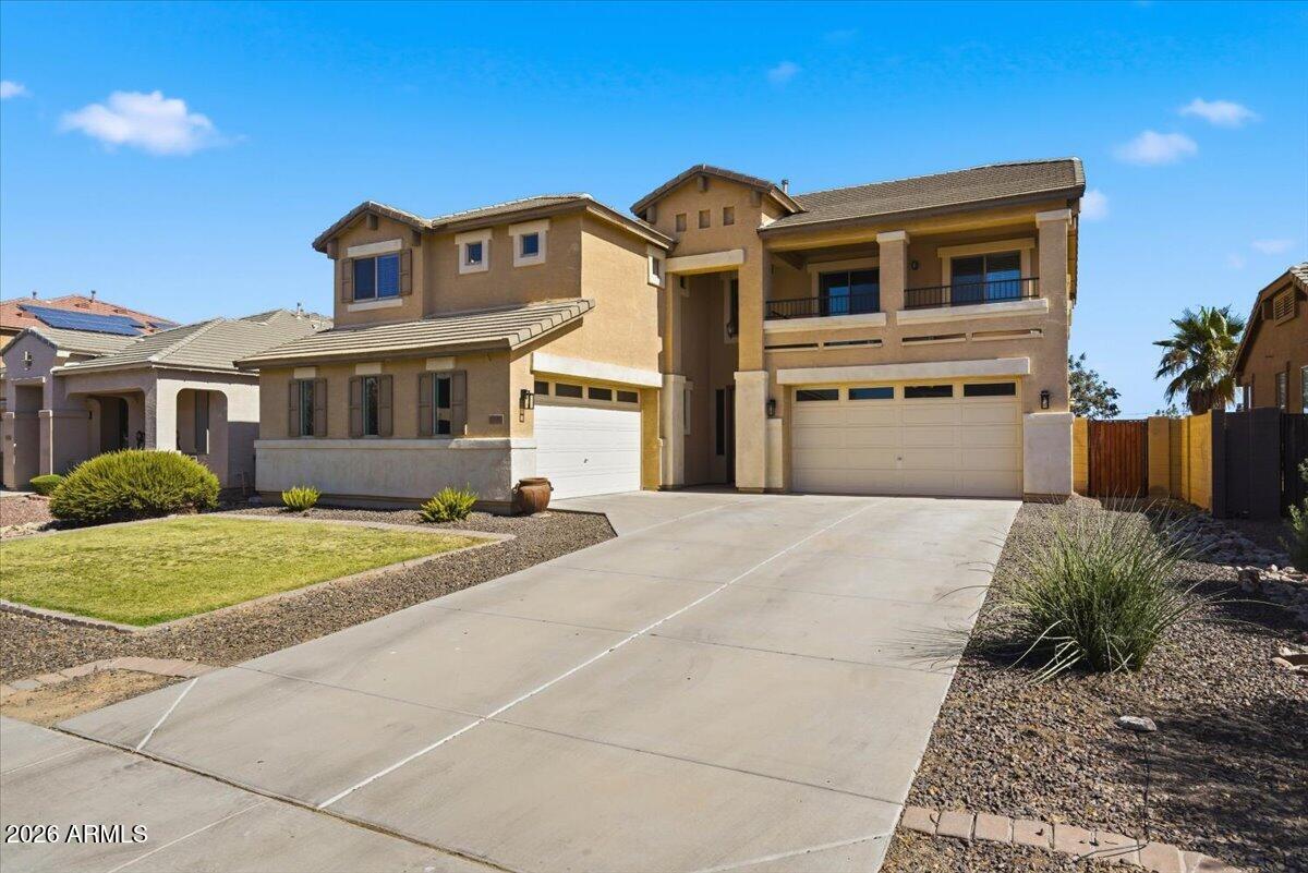 Welcome home and step inside to find fresh interior paint and updated wood and laminate flooring throughout. NO CARPET-creating a clean, modern feel that's both stylish and low maintenance. Built in 2007, situated on an upgraded lot, with no backyard neighbors. This home offers a functional and inviting layout with multiple living and entertaining spaces. The kitchen offers ample cabinetry, generous counter space, and a layout that flows seamlessly into the family room, ideal for gathering with friends and family. Heading upstairs, you can see the grand banister that opens up the entire space. Walk-in closets in every room, plus a versatile loft space ideal for a game room, home office, or additional living area. The primary suite offers a comfortable oversized retreat, with a garden tub and separate shower. A place to unwind from your weekly grind. Enjoy Arizona living in the backyard with space to create your own outdoor oasis, complete with mature fruit trees and a water-plummed garden bed. Additional highlights include TWO double-car garages for extra parking and/or storage space. This home combines comfort, convenience, and room to grow. Turnkey you won't want to miss!