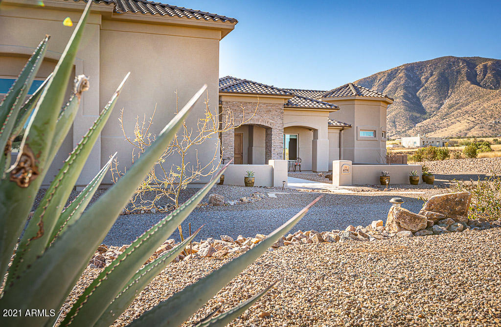 Beautiful custom built home in the prestigious, gated subdivision of Wild Horse! 
Many upgrades and VIEWS, VIEWS, VIEWS!!! This 3 bdrm, 3 bth, 2 car garage, plus a huge 40' RV garage home includes 2 master suites with master baths & office/exercise room off the main master bdrm.  The 4th bonus room includes a custom built off the wall bed with dual wardrobe and pull out nightstands.  Great for another guest bedroom/office!  Keep cozy & warm in the winter with the energy efficient pellet fireplace in the living room!  Custom built in entertainment center with reclaimed barn wood & stack stone artistic touches adds to the rustic, but elegant character of this home. The kitchen is a gourmet cook's dream! Two kitchen sinks, including a veggie prep island, double convection ovens, 5 burner gas stove, and get this...a pot filler! No longer will you have to haul a five gallon pot of water from the sink to the stove...just fill it up at the burner! Oh, and did I mention the 8' x 16' swim spa? Yes, enjoy exercising in your endless pool, or sit back and relax in a hot spa year round! I can go on and on, but this is definitely a home you want to see to appreciate!  Contact me for a private showing.